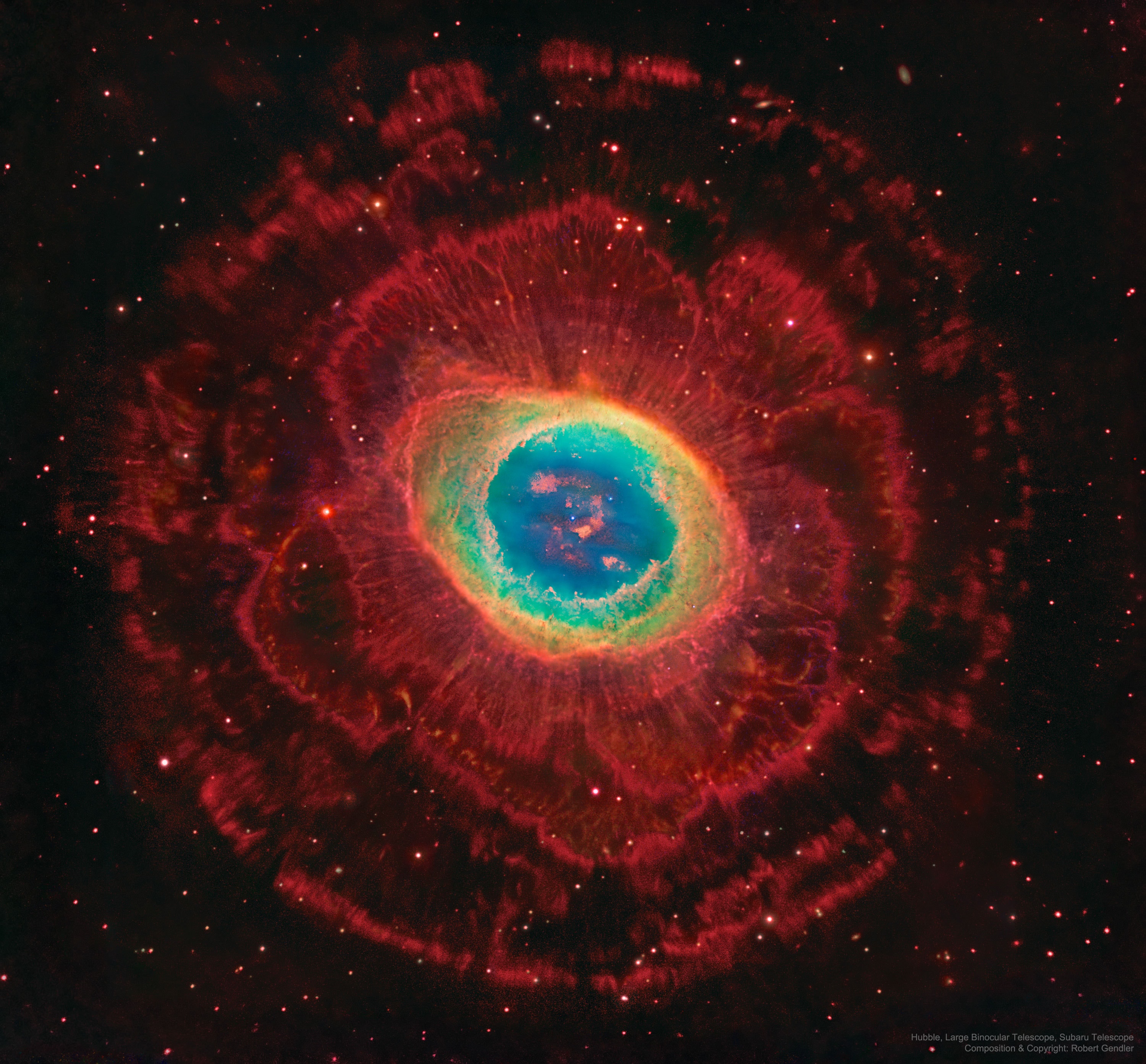 The Ring Nebula (M57), is more complicated than it appears through a small telescope.  The easily visible central ring is about one light-year across, but this remarkably deep exposure - a collaborative effort combining data from three different large telescopes - explores the looping filaments of glowing gas extending much farther from the nebula's central star. This composite image includes red light emitted by hydrogen as well as visible and infrared light. The Ring Nebula is an elongated planetary nebula, a type of nebula created when a Sun-like star evolves to throw off its outer atmosphere to become a white dwarf star.  The Ring Nebula is about 2,500 light-years away toward the musical constellation Lyra.   Amateur Astronomers: Please take the Night Sky Network's Survey