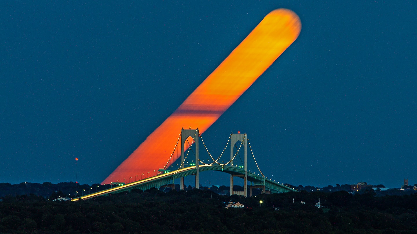 Famed in festival, story, and song the best known full moon is the Harvest Moon. For northern hemisphere dwellers that's a traditional name of the full moon nearest the September equinox. Seen from Saunderstown, Rhode Island, planet Earth, this Harvest Moon left a broad streak of warm hues as it rose through a twilight sky over the Newport Bridge. On September 20 its trail was captured in a single 22 minute exposure using a dense filter and a digital camera. Only two days later the September equinox marked a change of season and the beginning of autumn in the north. In fact, recognizing a season as the time between solstice and equinox, this Harvest Moon was the fourth full moon of the season, coming just before the astronomical end of northern summer.