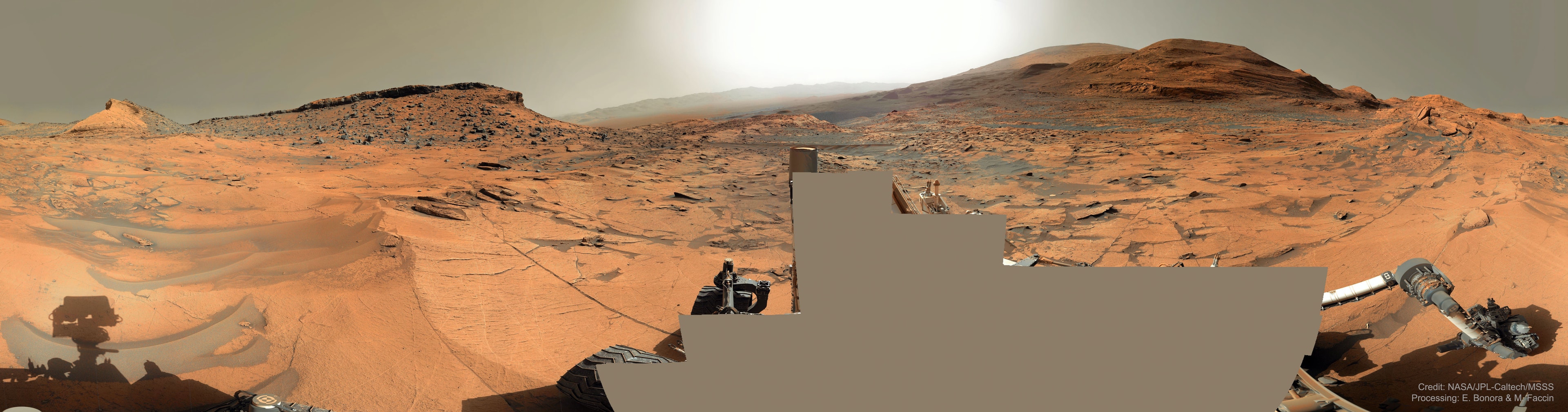Which way up Mount Sharp? In early September, the robotic rover Curiosity continued its ascent up the central peak of Gale Crater, searching for more clues about ancient water and further evidence that Mars could once have been capable of supporting life.  On this recent Martian morning, before exploratory drilling, the rolling rover took this 360-degree panorama, in part to help Curiosity's human team back on Earth access the landscape and chart possible future routes.  In the horizontally-compressed featured image, an amazing vista across Mars was captured, complete with layered hills, red rocky ground, gray drifting sand, and a dusty atmosphere. The hill just left of center has been dubbed Maria Gordon Notch in honor of a famous Scottish geologist.  The current plan is to direct Curiosity to approach, study, and pass just to the right of Gordon Notch on its exploratory trek.