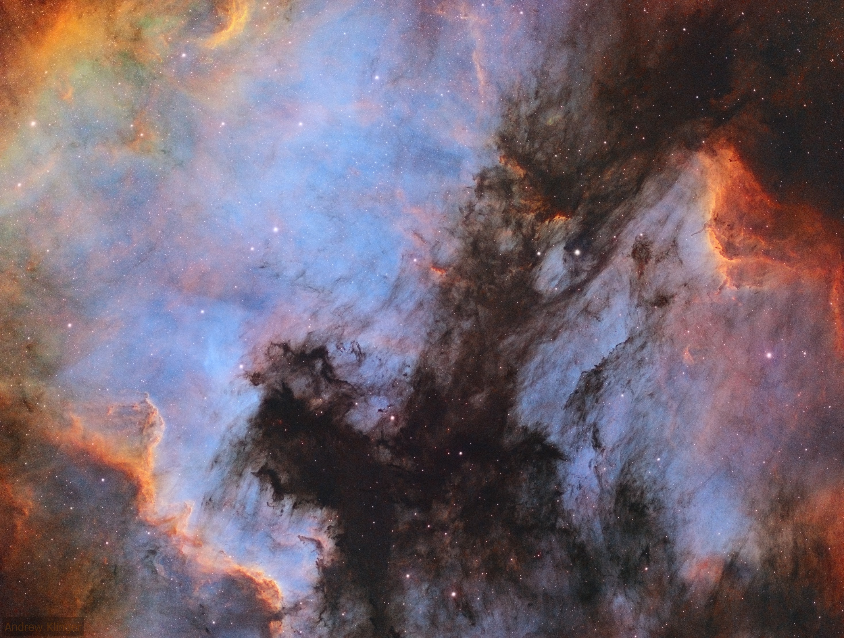 Fans of our fair planet might recognize the outlines of these cosmic clouds. On the left, bright emission outlined by dark, obscuring dust lanes seems to trace a continental shape, lending the popular name North America Nebula to the emission region cataloged as NGC 7000. To the right, just off the North America Nebula's east coast, is IC 5070, whose avian profile suggests the Pelican Nebula.  The two bright nebulae are about 1,500 light-years away, part of the same large and complex star forming region, almost as nearby as the better-known Orion Nebula. At that distance, the 3 degree wide field of view would span 80 light-years. This careful cosmic portrait uses narrow band images combined to highlight the bright ionization fronts and the characteristic glow from atomic hydrogen, sulfur, and oxygen gas. These nebulae can be seen with binoculars from a dark location.  Look northeast of bright star Deneb in the constellation Cygnus the Swan.
