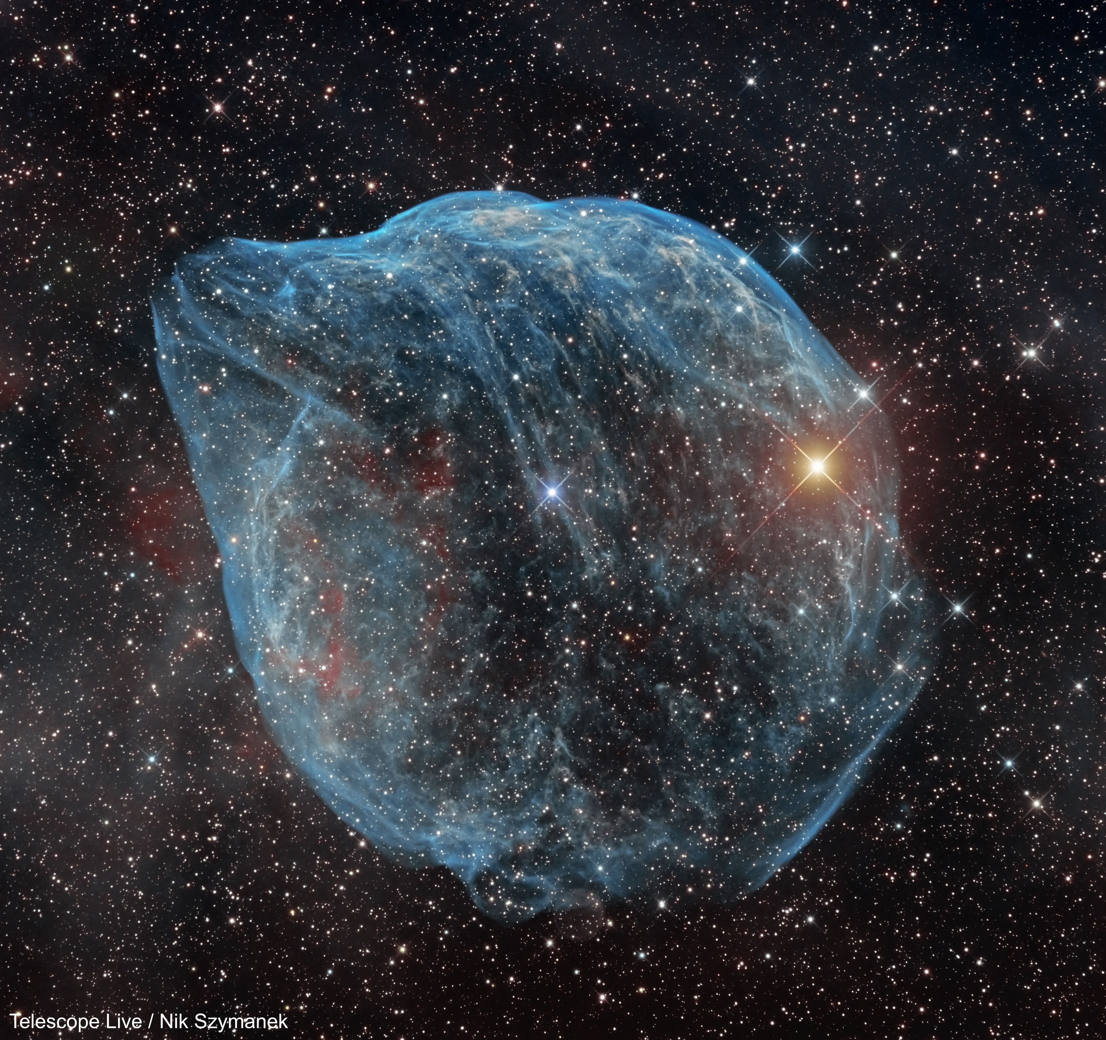 Blown by fast winds from a hot, massive star, this cosmic bubble is huge. Cataloged as Sharpless 2-308 it lies some 5,000 light-years away toward the constellation of the Big Dog (Canis Major) and covers slightly more of the sky than a Full Moon. That corresponds to a diameter of 60 light-years at its estimated distance. The massive star that created the bubble, a Wolf-Rayet star, is the bright one near the center of the nebula. Wolf-Rayet stars have over 20 times the mass of the Sun and are thought to be in a brief, pre-supernova phase of massive star evolution. Fast winds from this Wolf-Rayet star create the bubble-shaped nebula as they sweep up slower moving material from an earlier phase of evolution. The windblown nebula has an age of about 70,000 years. Relatively faint emission captured by narrowband filters in the deep image is dominated by the glow of ionized oxygen atoms mapped to a blue hue. Presenting a mostly harmless outline, SH2-308 is also known as The Dolphin-head Nebula.
