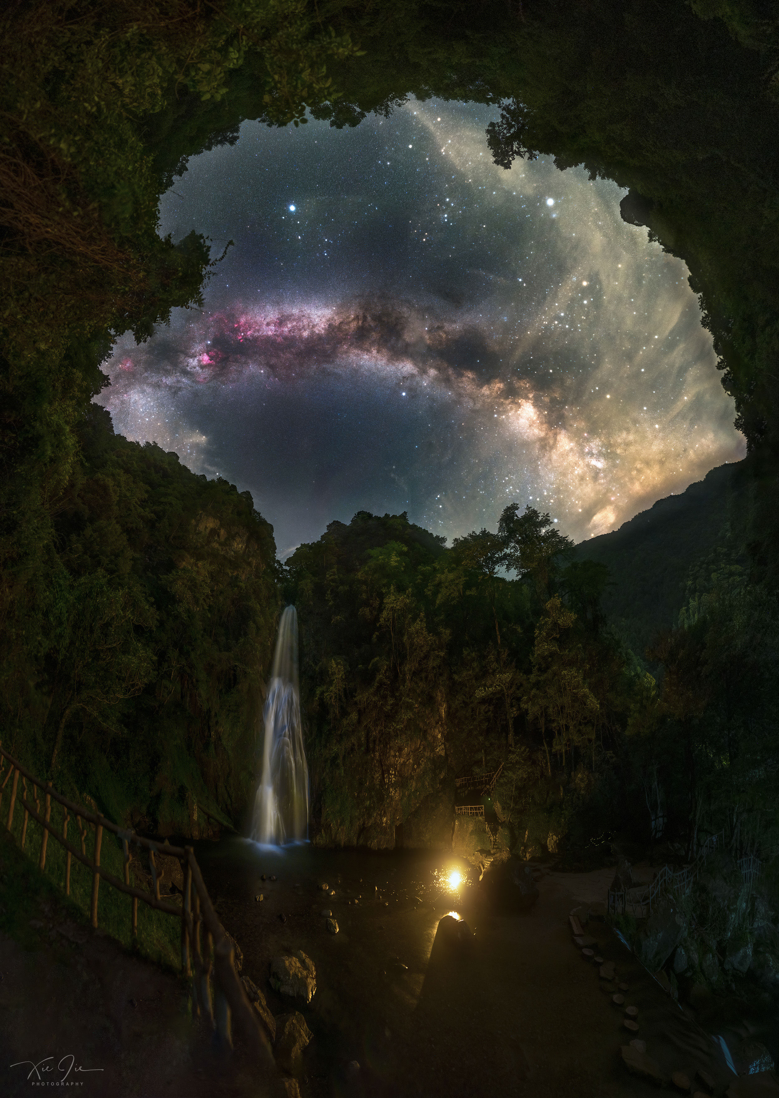 The dream was to capture both the waterfall and the Milky Way together. Difficulties included finding a good camera location, artificially illuminating the waterfall and the surrounding valley effectively, capturing the entire scene with numerous foreground and background shots, worrying that fireflies would be too distracting, keeping the camera dry, and avoiding stepping on a poisonous snake.  Behold the result -- captured after midnight in mid-July and digitally stitched into a wide-angle panorama. The waterfall is the picturesque Zhulian waterfall in the Luoxiao Mountains in eastern Hunan Province, China. The central band of our Milky Way Galaxy crosses the sky and shows numerous dark dust filaments and colorful nebulas. Bright stars dot the sky -- all residing in the nearby Milky Way -- including the Summer Triangle with bright Vega visible above the Milky Way's arch. After capturing all 78 component exposures for you to enjoy, the photographer and friends enjoyed the view themselves for the rest of the night.    Discovery + Outreach: Graduate student research position open for APOD
