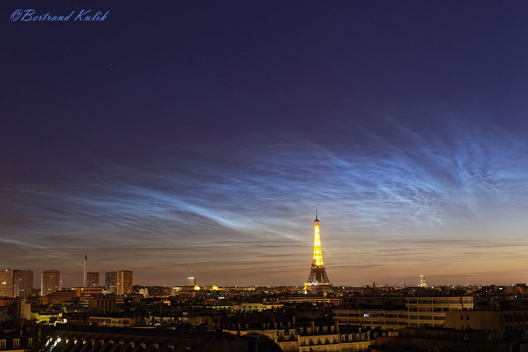 It's northern noctilucent cloud season. Composed of small ice crystals forming only during specific conditions in the upper atmosphere, noctilucent clouds may become visible at sunset during late summer when illuminated by sunlight from below.  Noctilucent clouds are the highest clouds known and now established to be polar mesospheric clouds observed from the ground.  Although observed with NASA's AIM satellite since 2007, much about noctilucent clouds remains unknown and so a topic of active research. The featured image shows expansive and rippled noctilucent clouds wafting over Paris, France. This year, several northern locations are already reporting especially vivid displays of noctilucent clouds.