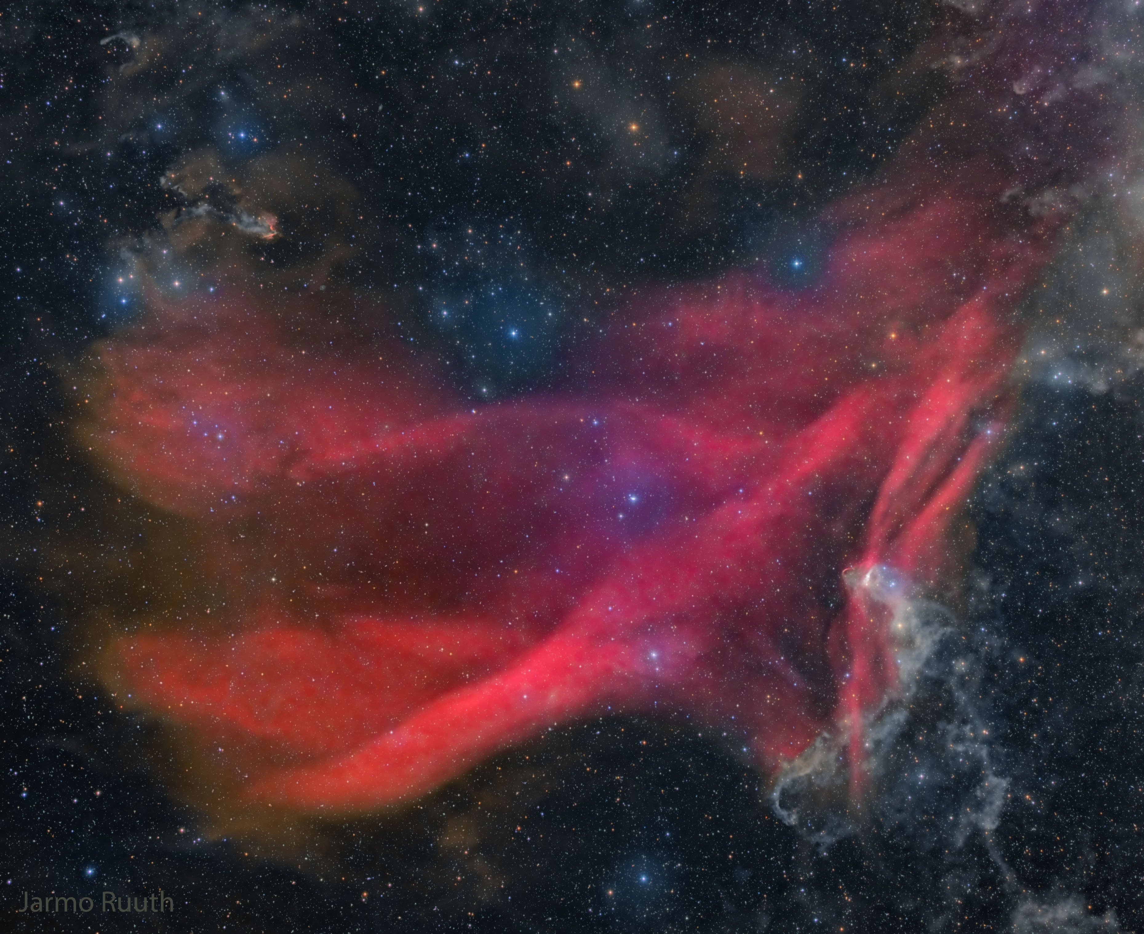 It is one of the largest nebulas on the sky -- why isn't it better known? Roughly the same angular size as the Andromeda Galaxy, the Great Lacerta Nebula can be found toward the constellation of the Lizard (Lacerta). The emission nebula is difficult to see with wide-field binoculars because it is so faint, but also usually difficult to see with a large telescope because it is so great in angle -- spanning about three degrees. The depth, breadth, waves, and beauty of the nebula -- cataloged as Sharpless 126 (Sh2-126) -- can best be seen and appreciated with a long duration camera exposure. The featured image is one such combined exposure -- in this case 10 hours over five different colors and over six nights during this past June and July at the IC Astronomy Observatory in Spain. The hydrogen gas in the Great Lacerta Nebula glows red because it is excited by light from the bright star 10 Lacertae, one of the bright blue stars just above the red-glowing nebula's center.  The stars and nebula are about 1,200 light years distant.    Harvest Full Moon 2022: Notable Submissions to APOD