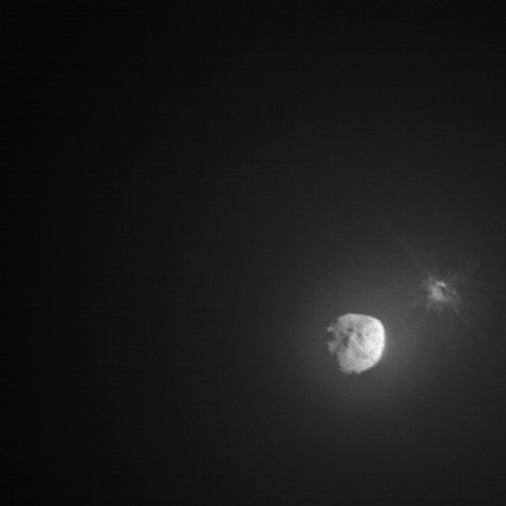 Fifteen days before impact, the DART spacecraft deployed a small companion satellite to document its historic planetary defense technology demonstration. Provided by the Italian Space Agency, the Light Italian CubeSat for Imaging Asteroids, aka LICIACube, recorded this image of the event's aftermath. A cloud of ejecta is seen near the right edge of the frame captured only minutes following DART's impact with target asteroid Dimorphos while LICIACube was about 80 kilometers away. Presently about 11 million kilometers from Earth, 160 meter diameter Dimorphos is a moonlet orbiting 780 meter diameter asteroid Didymos. Didymos is seen off center in the LICIACube image. Over the coming weeks, ground-based telescopic observations will look for a small change in Dimorphos' orbit around Didymos to evaluate how effectively the DART impact deflected its target.