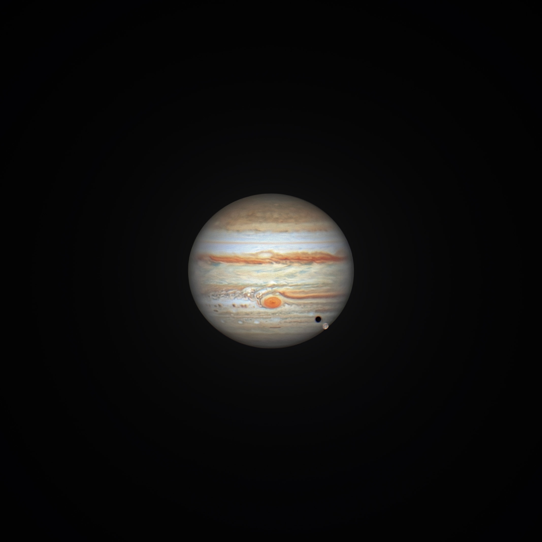 At opposition, opposite the Sun in Earth's sky, late last month Jupiter is also approaching perihelion, the closest point to the Sun in its elliptical orbit, early next year. That makes Jupiter exceptionally close to our fair planet, currently resulting in excellent views of the Solar System's ruling gas giant. On September 27, this sharp image of Jupiter was recorded with a small telescope from a backyard in Florence, Arizona. The stacked video frames reveal the massive world bounded by planet girdling winds. Dark belts and light zones span the gas giant, along with rotating oval storms and its signature Great Red Spot. Galilean moon Ganymede is below and right in the frame. The Solar System's largest moon and its shadow are in transit across the southern Jovian cloud tops.