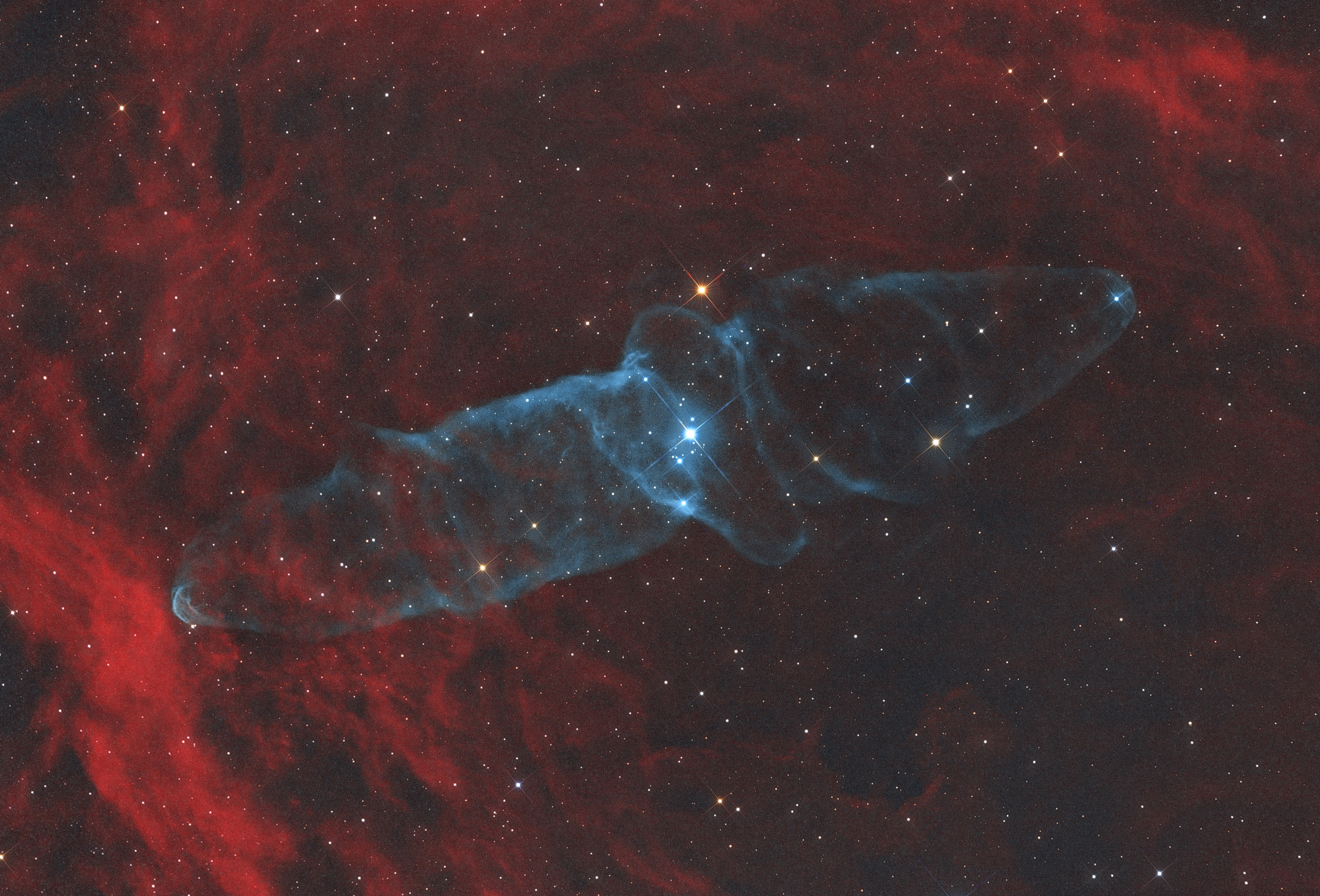 A mysterious squid-like cosmic cloud, this nebula is very faint, but also very large in planet Earth's sky. In the image, composed with 30 hours of narrowband image data, it spans nearly three full moons toward the royal constellation Cepheus. Discovered in 2011 by French astro-imager Nicolas Outters, the Squid Nebula's bipolar shape is distinguished here by the telltale blue-green emission from doubly ionized oxygen atoms. Though apparently surrounded by the reddish hydrogen emission region Sh2-129, the true distance and nature of the Squid Nebula have been difficult to determine. Still, a more recent investigation suggests Ou4 really does lie within Sh2-129 some 2,300 light-years away. Consistent with that scenario, the cosmic squid would represent a spectacular outflow of material driven by a triple system of hot, massive stars, cataloged as HR8119, seen near the center of the nebula. If so, this truly giant squid nebula would physically be over 50 light-years across.