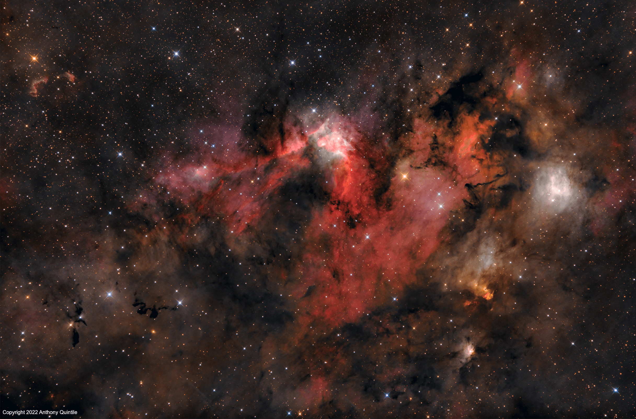 This colorful skyscape spans about four full moons across nebula rich starfields along the plane of our Milky Way Galaxy in the royal northern constellation Cepheus. Near the edge of the region's massive molecular cloud some 2,400 light-years away, bright reddish emission region Sharpless (Sh) 155 is at the center of the frame, also known as the Cave Nebula. About 10 light-years across the cosmic cave's bright walls of gas are ionized by ultraviolet light from the hot young stars around it. Dusty reflection nebulae, like vdB 155 to the right, and dense obscuring clouds of dust also abound on the interstellar canvas. Astronomical explorations have revealed other dramatic signs of star formation, including the bright reddish fleck of Herbig-Haro (HH) 168. Below and right of center, the Herbig-Haro object emission is generated by energetic jets from a newborn star.