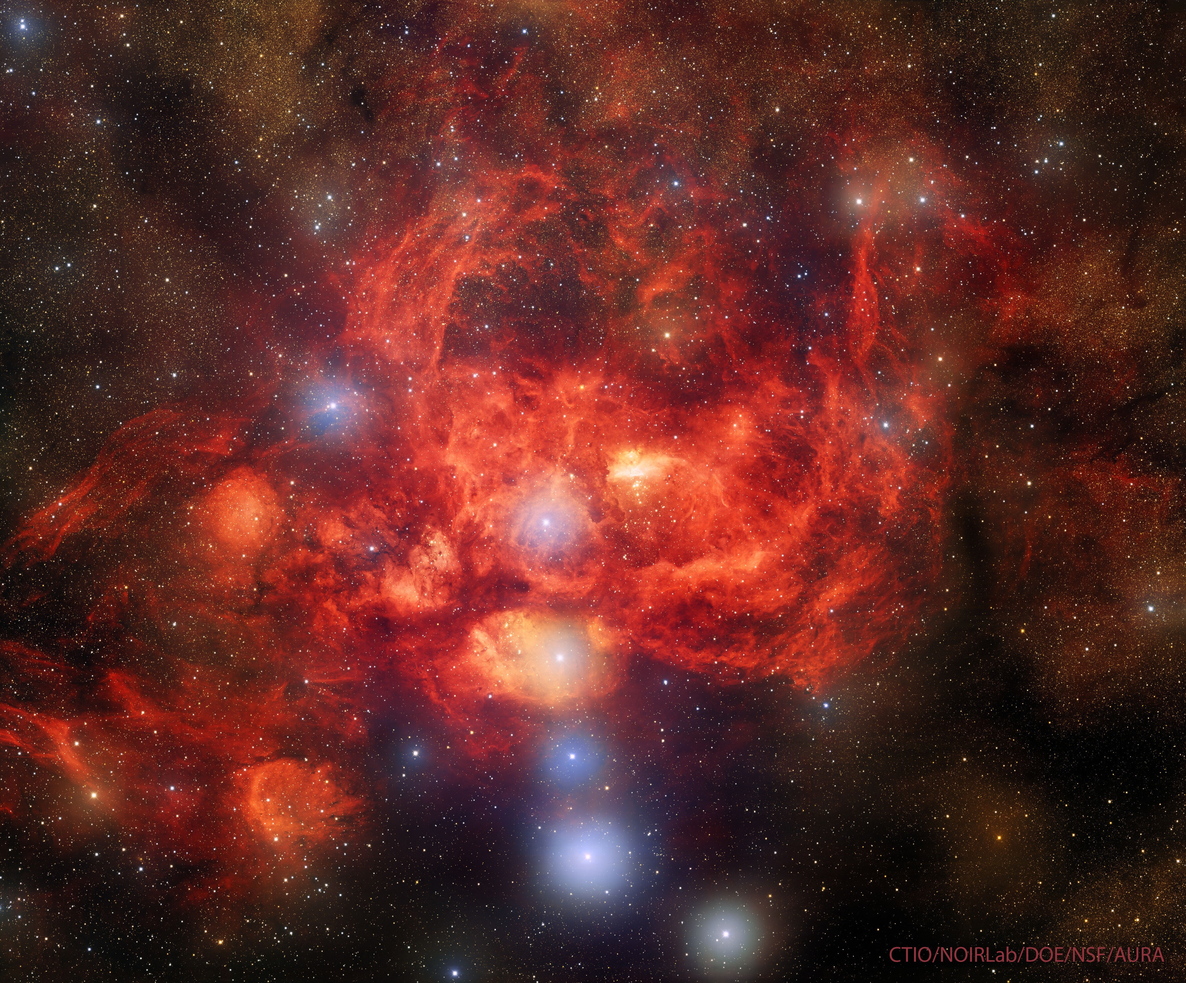 Why is the Lobster Nebula forming some of the most massive stars known? No one is yet sure.  Cataloged as NGC 6357, the Lobster Nebula houses the open star cluster Pismis 24 near its center -- a home to unusually bright and massive stars.  The overall red glow near the inner star forming region results from the emission of ionized hydrogen gas.   The surrounding nebula, featured here, holds a complex tapestry of gas, dark dust, stars still forming, and newly born stars.  The intricate patterns are caused by complex interactions between interstellar winds, radiation pressures, magnetic fields, and gravity.  The image was taken with DOE's Dark Energy Camera on the 4-meter Blanco Telescope at the Cerro Tololo Inter-American Observatory in Chile. NGC 6357 spans about 400 light years and lies about 8,000 light years away toward the constellation of the Scorpion.