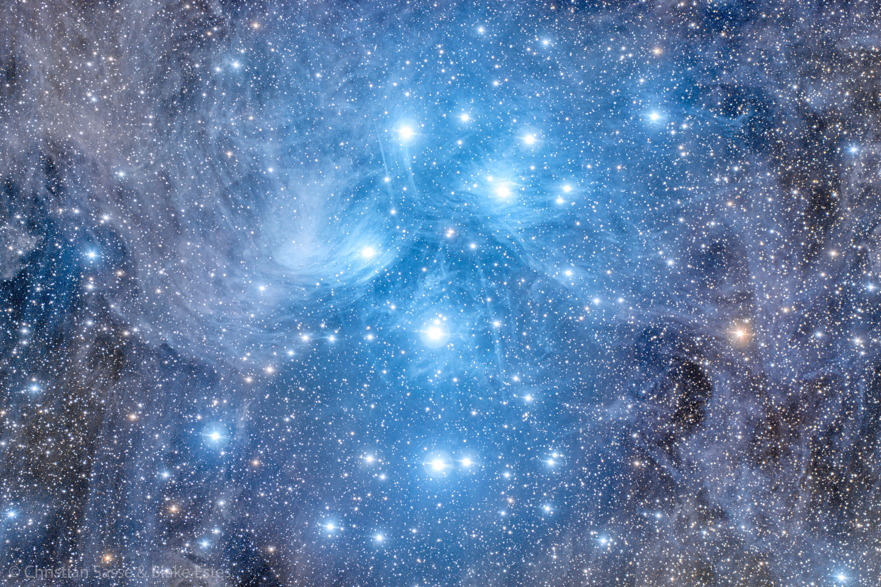 Have you ever seen the Pleiades star cluster? Even if you have, you probably have never seen it as large and clear as this. Perhaps the most famous star cluster on the sky, the bright stars of the Pleiades can be seen with the unaided eye even from the depths of a light-polluted city.  With a long exposure from a dark location, though, the dust cloud surrounding the Pleiades star cluster becomes very evident. The featured 11-hour exposure, taken from the Siding Spring Observatory in Australia, covers a sky area several times the size of the full moon.  Also known as the Seven Sisters and M45, the Pleiades lies about 400 light years away toward the constellation of the Bull (Taurus).  A common legend with a modern twist is that one of the brighter stars faded since the cluster was named, leaving only six of the sister stars visible to the unaided eye. The actual number of Pleiades stars visible, however, may be more or less than seven, depending on the darkness of the surrounding sky and the clarity of the observer's eyesight.   Your Sky Surprise: What picture did APOD feature on your birthday? (post 1995)
