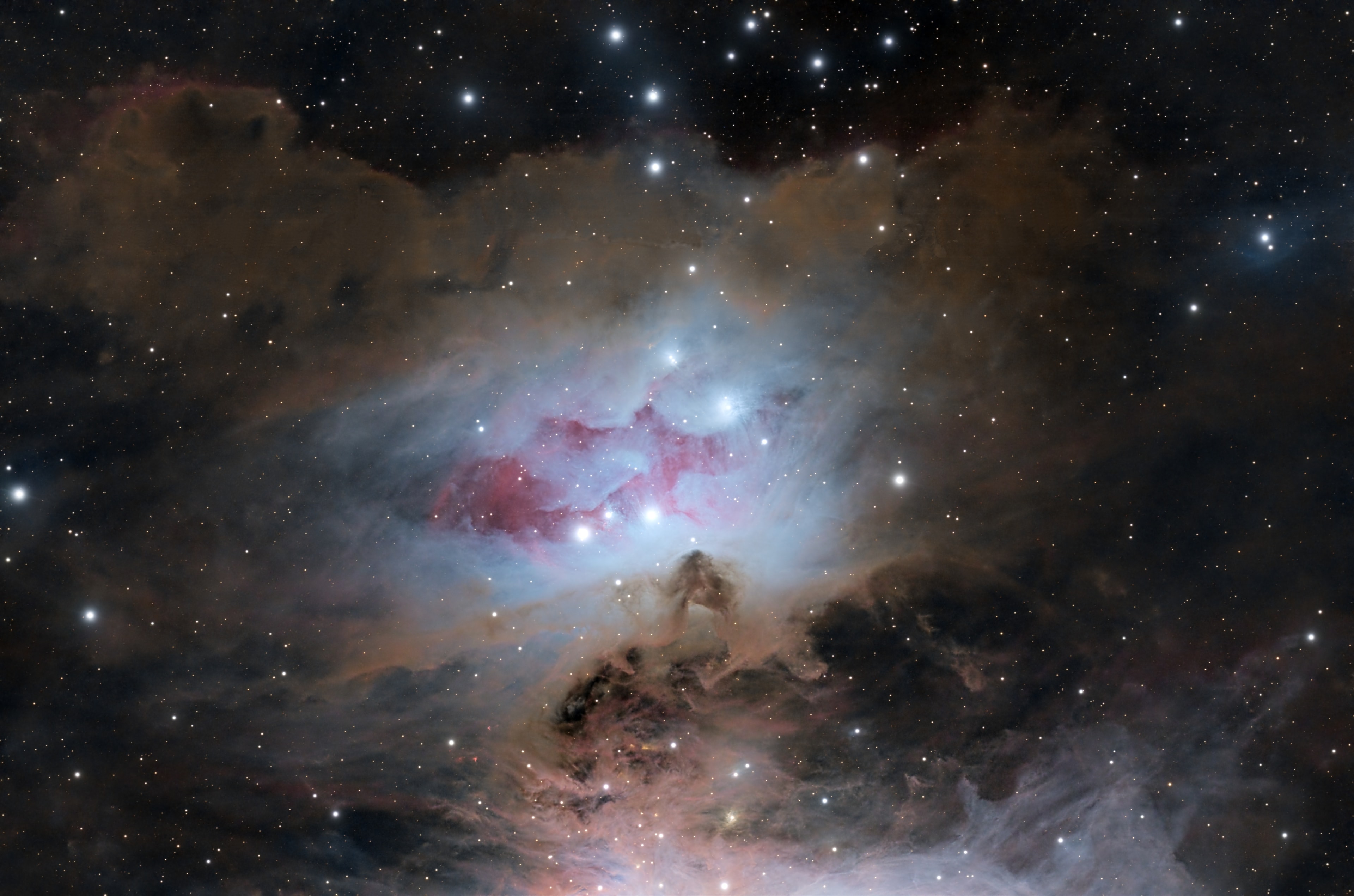 The 1970s are sometimes ignored by astronomers. For example, this beautiful grouping of reflection nebulae in Orion - NGC 1977, NGC 1975, and NGC 1973 - is usually overlooked in favor of the substantial glow from the nearby stellar nursery better known as the Orion Nebula. Found along Orion's sword just north of the bright Orion Nebula complex, these reflection nebulae are also associated with Orion's giant molecular cloud about 1,500 light-years away, but are dominated by the characteristic blue color of interstellar dust reflecting light from hot young stars. In this sharp color image a portion of the Orion Nebula appears along the bottom border with the cluster of reflection nebulae at picture center. NGC 1977 stretches across the field just below center, separated from NGC 1973 (above right) and NGC 1975 (above left) by dark regions laced with faint red emission from hydrogen atoms. Taken together, the dark regions suggest the popular moniker, the Running Man Nebula. At the estimated distance of Orion's dusty molecular cloud this running man would be about 15 light-years across.