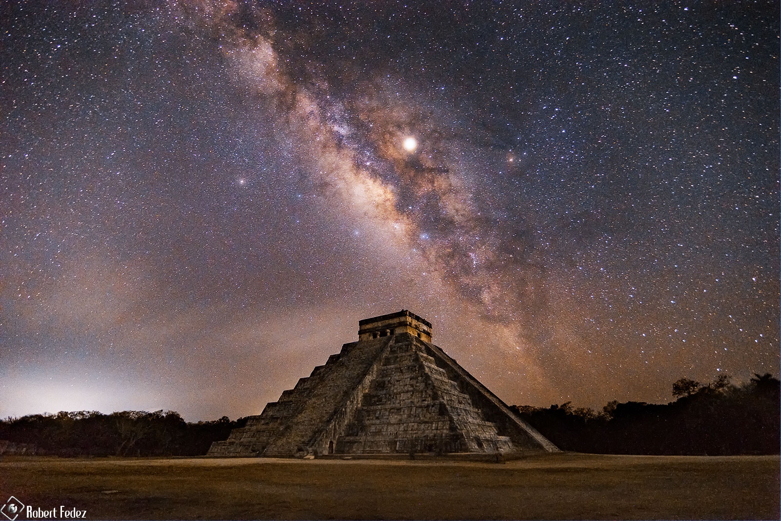 To see the feathered serpent descend the Mayan pyramid requires exquisite timing.  You must visit El Castillo -- in Mexico's Yucatán Peninsula -- near an equinox.  Then, during the late afternoon if the sky is clear, the pyramid's own shadows create triangles that merge into the famous illusion of a slithering viper.  Also known as the Temple of Kukulkan, the impressive step-pyramid stands 30 meters tall and 55 meters wide at the base.  Built up as a series of square terraces by the pre-Columbian civilization between the 9th and 12th century, the structure can be used as a calendar and is noted for astronomical alignments. The featured composite image was captured in 2019 with Jupiter and Saturn straddling the diagonal central band of our Milky Way galaxy. Tomorrow marks another equinox -- not only at Temple of Kukulcán, but all over planet Earth.