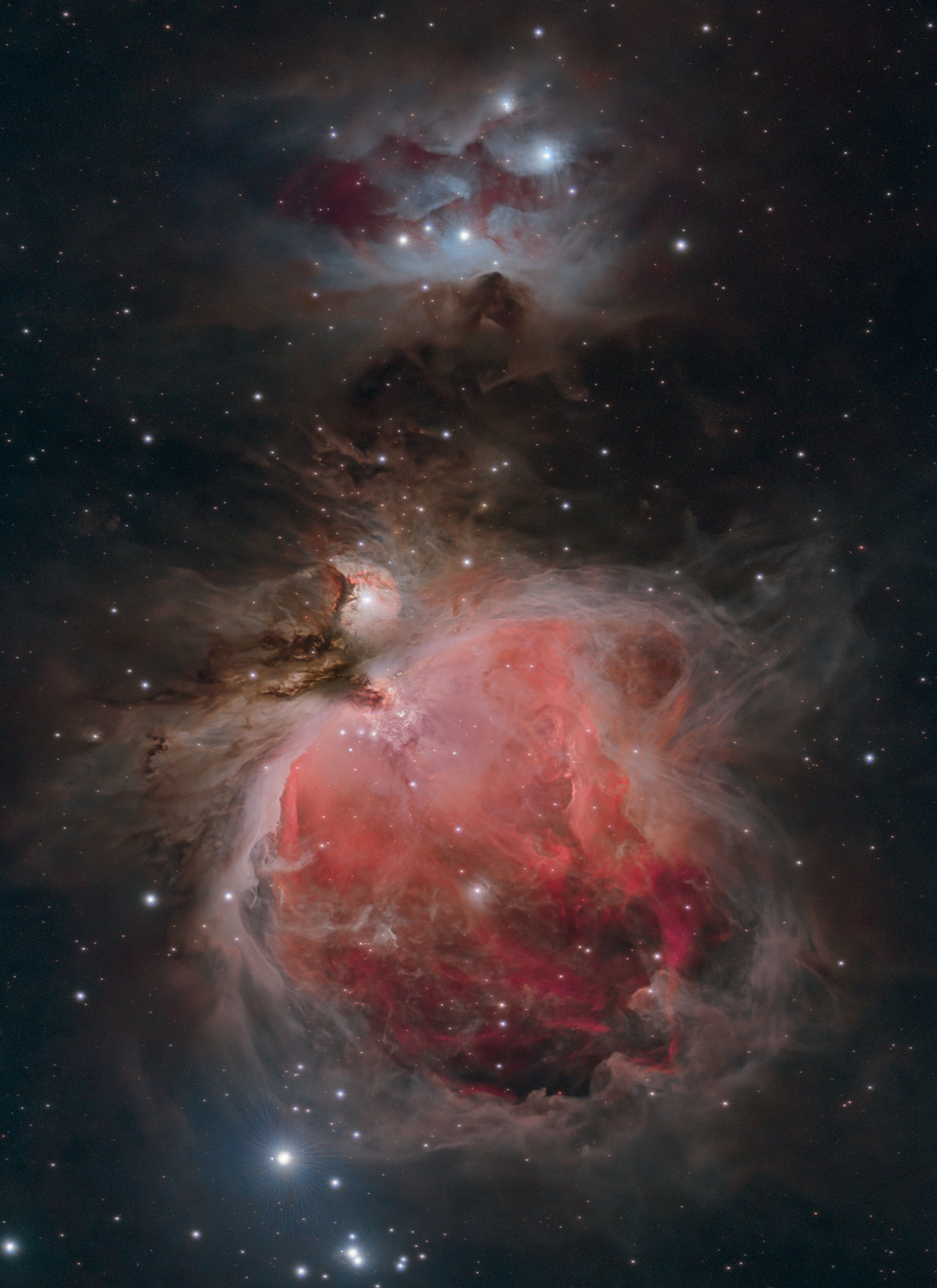 Few cosmic vistas excite the imagination like The Great Nebula in Orion. Visible as a faint celestial smudge to the naked-eye, the nearest large star-forming region sprawls across this sharp telescopic image, recorded on a cold January night in dark skies from West Virginia, planet Earth. Also known as M42, the Orion Nebula's glowing gas surrounds hot, young stars. About 40 light-years across, it lies at the edge of an immense interstellar molecular cloud only 1,500 light-years away within the same spiral arm of our Milky Way galaxy as the Sun. Along with dusty bluish reflection nebula NGC 1977 and friends near the top of the frame, the eye-catching nebulae represent only a small fraction of our galactic neighborhood's wealth of star-forming material. Within the well-studied stellar nursery, astronomers have also identified what appear to be numerous infant solar systems.