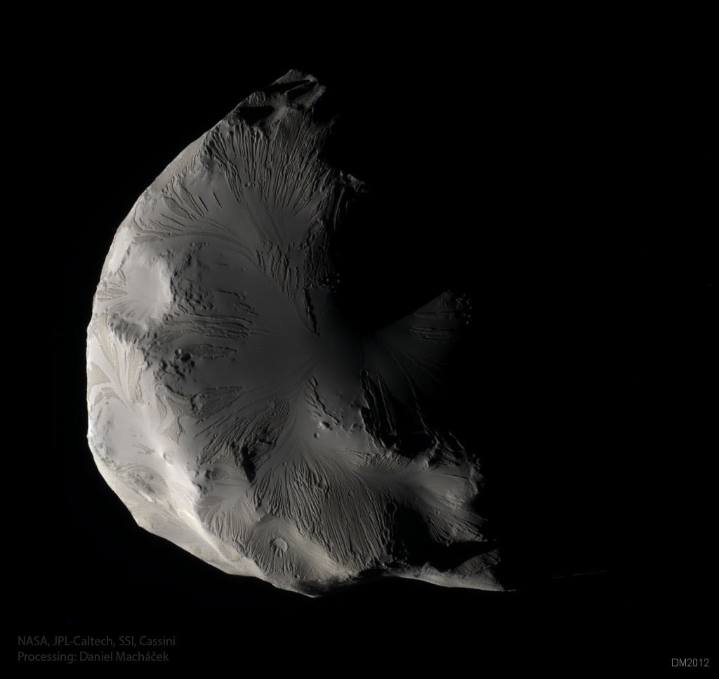 Although its colors may be subtle, Saturn's moon Helene is an enigma in any light. The moon was imaged in unprecedented detail in 2012 as the robotic Cassini spacecraft orbiting Saturn swooped to within a single Earth diameter of the diminutive moon. Although conventional craters and hills appear, the above image also shows terrain that appears unusually smooth and streaked. Planetary astronomers are inspecting these detailed images of Helene to glean clues about the origin and evolution of the 30-km across floating iceberg. Helene is also unusual because it circles Saturn just ahead of the large moon Dione, making it one of only four known Saturnian moons to occupy a gravitational dimple known as a stable Lagrange point.