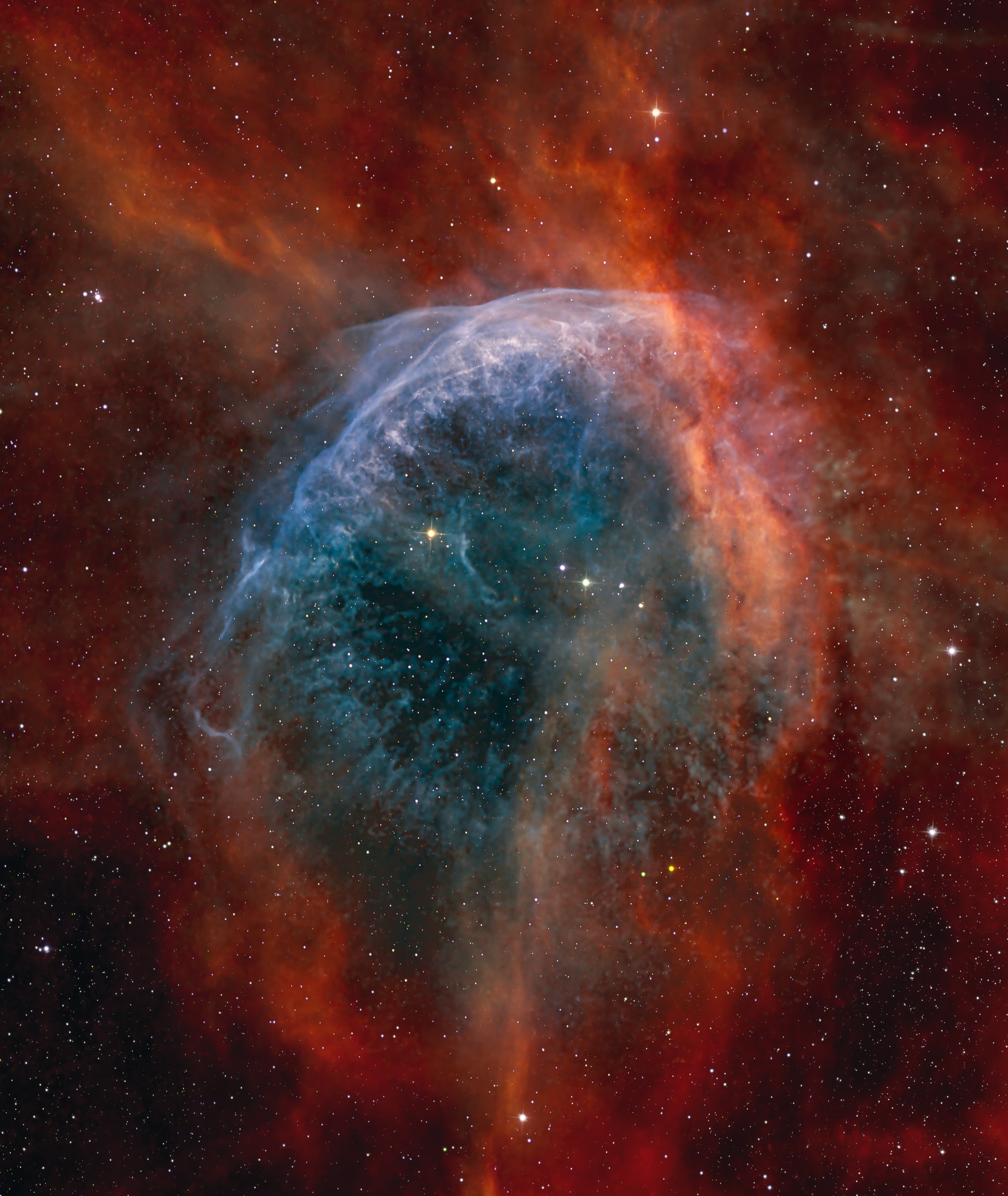 Made with narrowband filters, this cosmic snapshot covers a field of view about the size of the full Moon within the boundaries of the constellation Cygnus. It highlights the bright edge of a ring-like nebula traced by the glow of ionized sulfur, hydrogen, and oxygen gas. Embedded in the region's interstellar clouds of gas and dust, the complex, glowing arcs are sections of bubbles or shells of material swept up by the wind from Wolf-Rayet star WR 134, brightest star near the center of the frame. Distance estimates put WR 134 about 6,000 light-years away, making the frame over 50 light-years across. Shedding their outer envelopes in powerful stellar winds, massive Wolf-Rayet stars have burned through their nuclear fuel at a prodigious rate and end this final phase of massive star evolution in a spectacular supernova explosion. The stellar winds and final supernovae enrich the interstellar material with heavy elements to be incorporated in future generations of stars.
