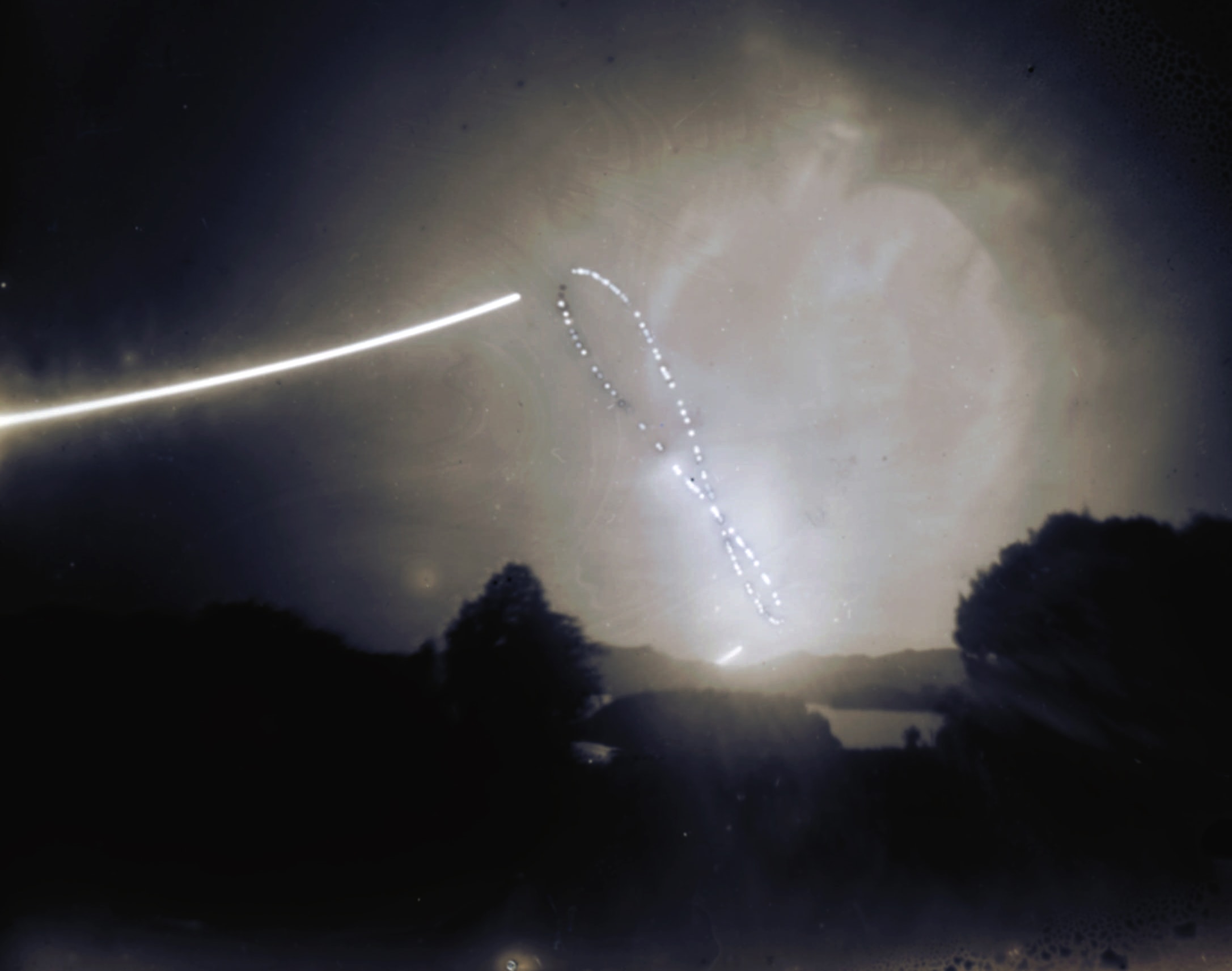 An analemma is that figure-8 curve you get when you mark the position of the Sun at the same time each day for one year. To make this one, a 4x5 pinhole camera was set up looking north in southern New Zealand skies. The shutter was briefly opened each clear day in the afternoon at 4pm local time exposing the same photosensitized glass plate for the year spanning September 23, 2022 to September 19, 2023. On two days, the winter and summer solstices, the shutter was opened again 15 minutes after the main exposure and remained open until sunset to create the sun trails at the bottom and top of the curve. The equinox dates correspond to positions in the middle of the curve, not the crossover point. Of course, the curve itself is inverted compared to an analemma traced from the northern hemisphere. And while fall begins today at the Autumnal Equinox for the northern hemisphere, it's the Spring Equinox in the south.