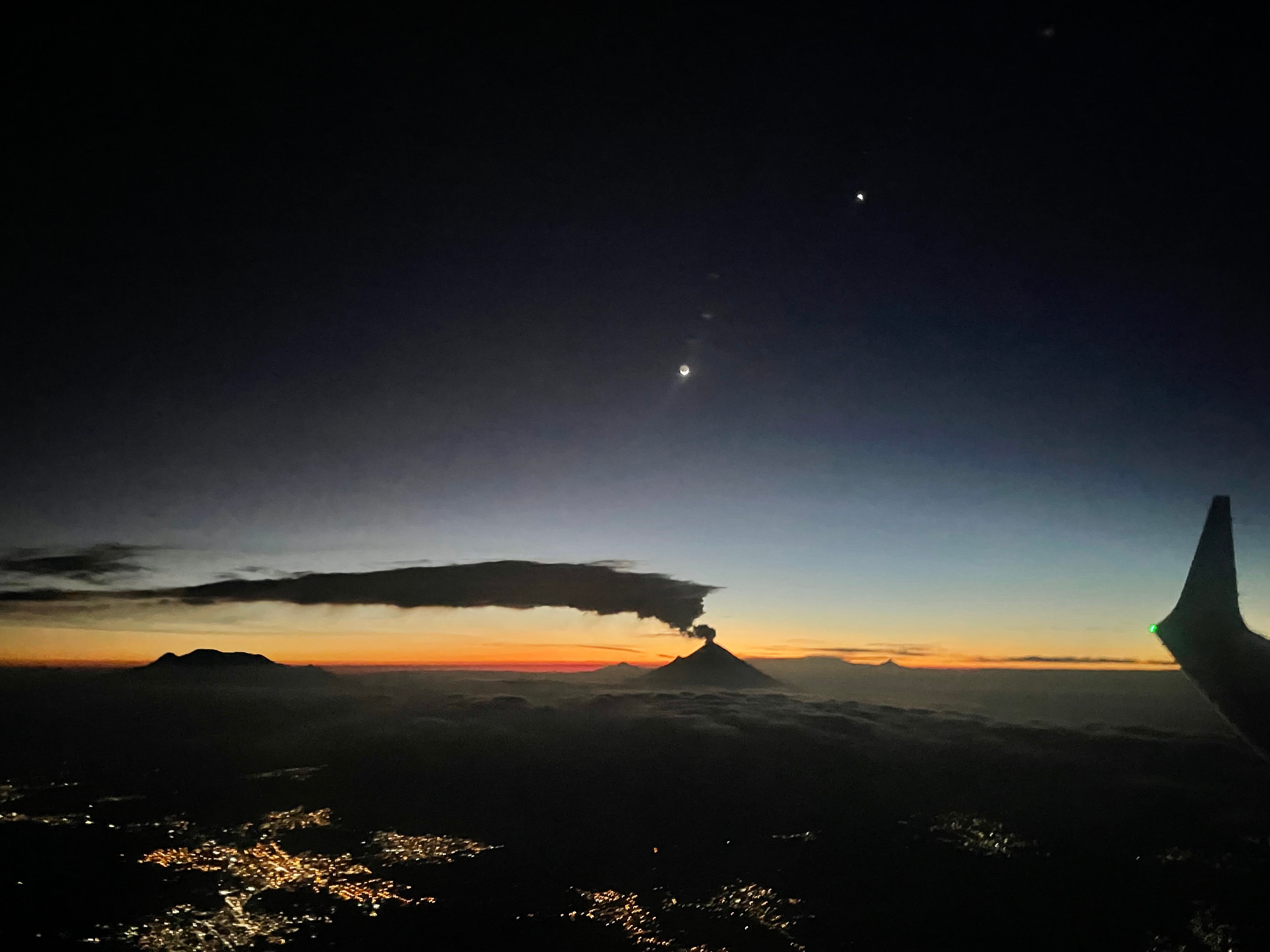 Venus has returned, now appearing in planet Earth's predawn skies as a brilliant morning star. From a window seat on a flight to Mexico City, the bright celestial beacon was captured just before sunrise in this astronomical snapshot, taken on September 12. Venus, at the upper right, shared the early twilight with an old crescent Moon. Seen from this stratospheric perspective, mountain peaks and clouds appear in silhouette along a glowing eastern horizon. The dramatic, long, low cloud bank was created by ongoing venting from planet Earth's active volcano Popocatépetl.