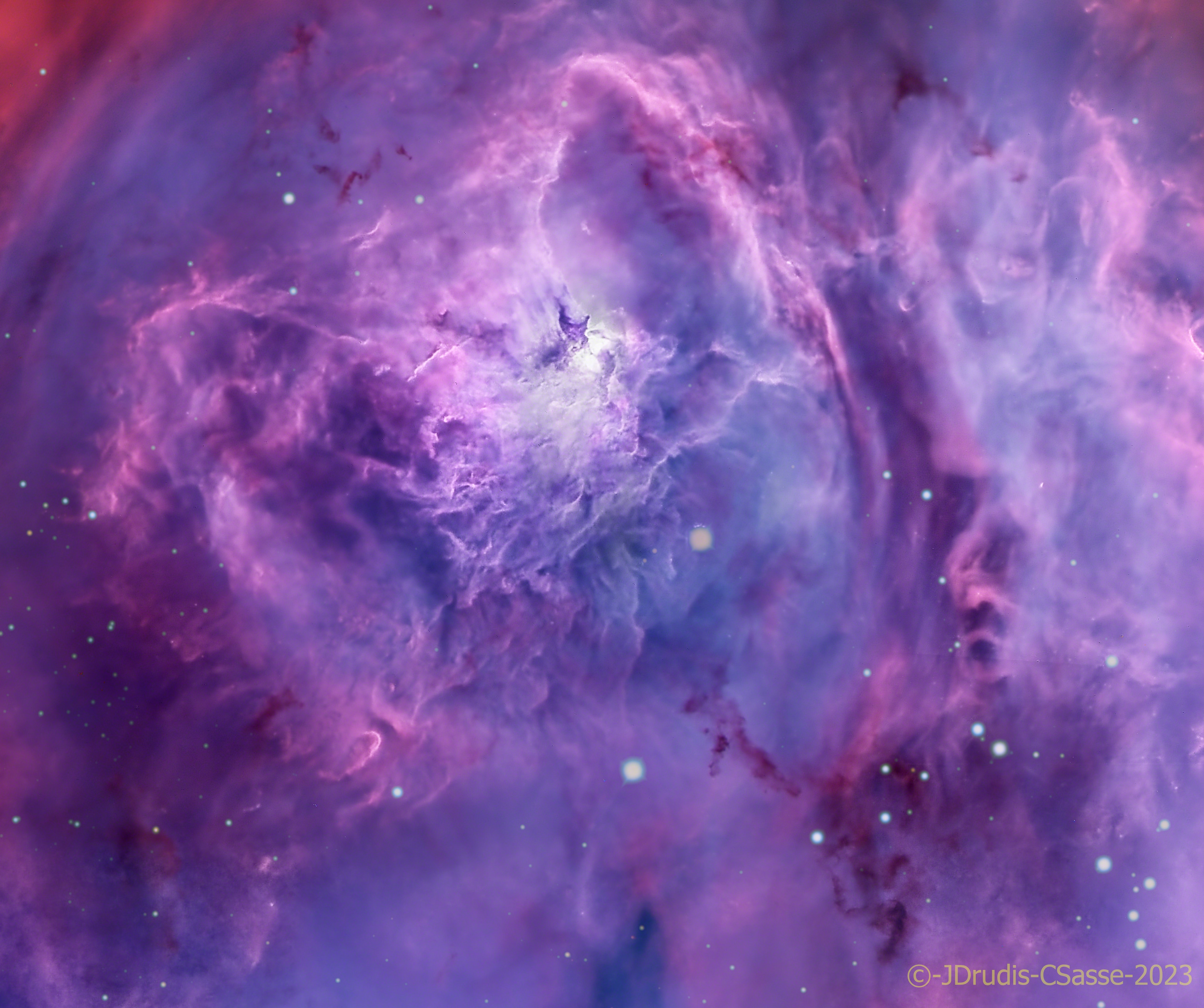 Ridges of glowing interstellar gas and dark dust clouds inhabit the turbulent, cosmic depths of the Lagoon Nebula. Also known as M8, The bright star forming region is about 5,000 light-years distant. It makes for a popular stop on telescopic tours of the constellation Sagittarius toward the center of our Milky Way Galaxy. Dominated by the telltale red emission of ionized hydrogen atoms recombining with stripped electrons, this deep telescopic view of the Lagoon's central reaches is about 40 light-years across. The bright hourglass shape near the center of the frame is gas ionized and sculpted by energetic radiation and extreme stellar winds from a massive young star.