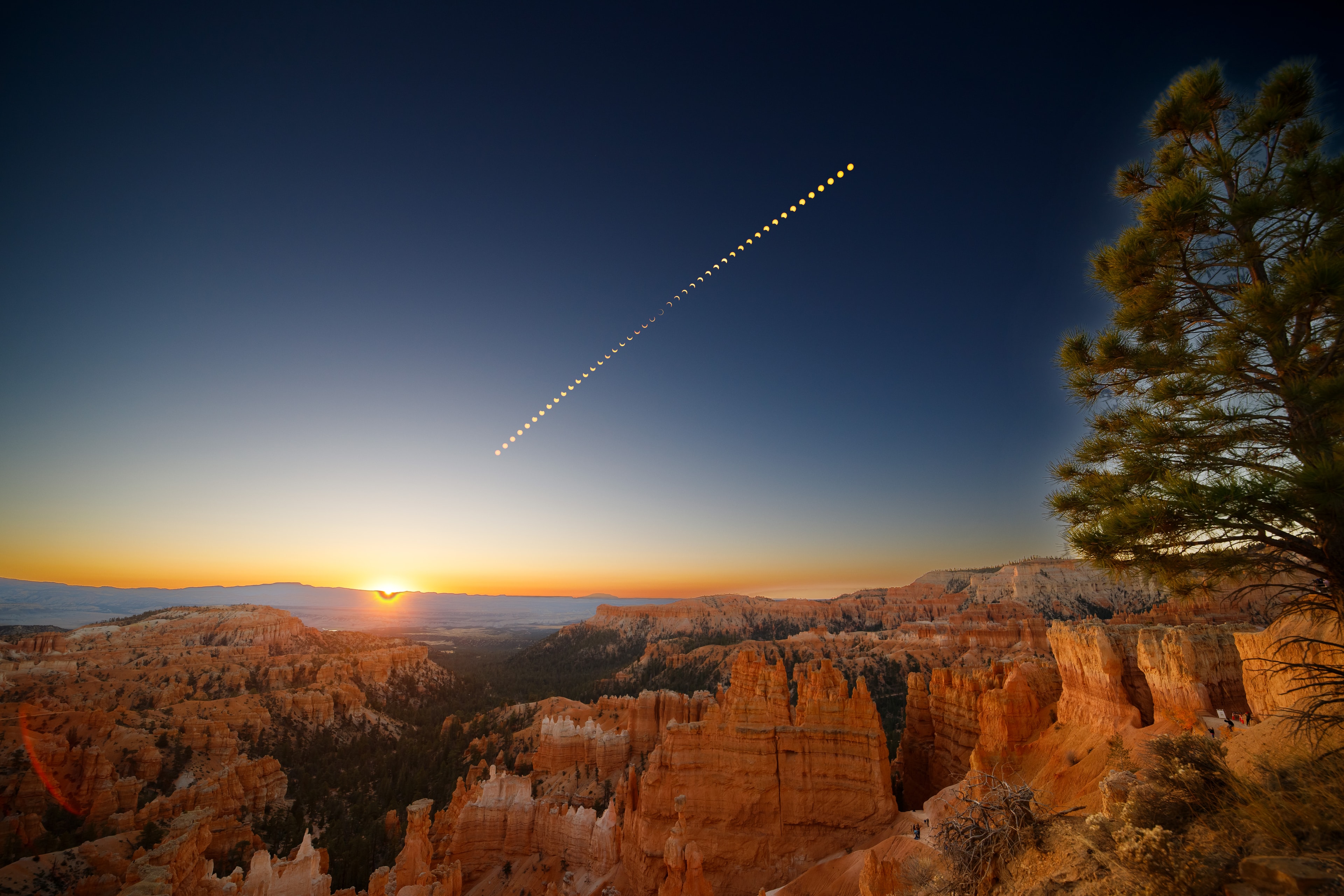 This timelapse series captured on October 14 is set against the sunrise view from Sunset Point, Bryce Canyon, planet Earth. Of course on that date the New Moon caught up with the Sun in the canyon's morning skies. Local temperatures fell as the Moon's shadow swept across the high altitude scene and the brilliant morning sunlight became a more subdued yellow hue cast over the reddish rocky landscape. In the timelapse series, images were taken at 2 minute intervals. The camera and solar filter were fixed to a tripod to follow the phases of the annular solar eclipse.   APOD Album: Annular Solar Eclipse of 2023 October