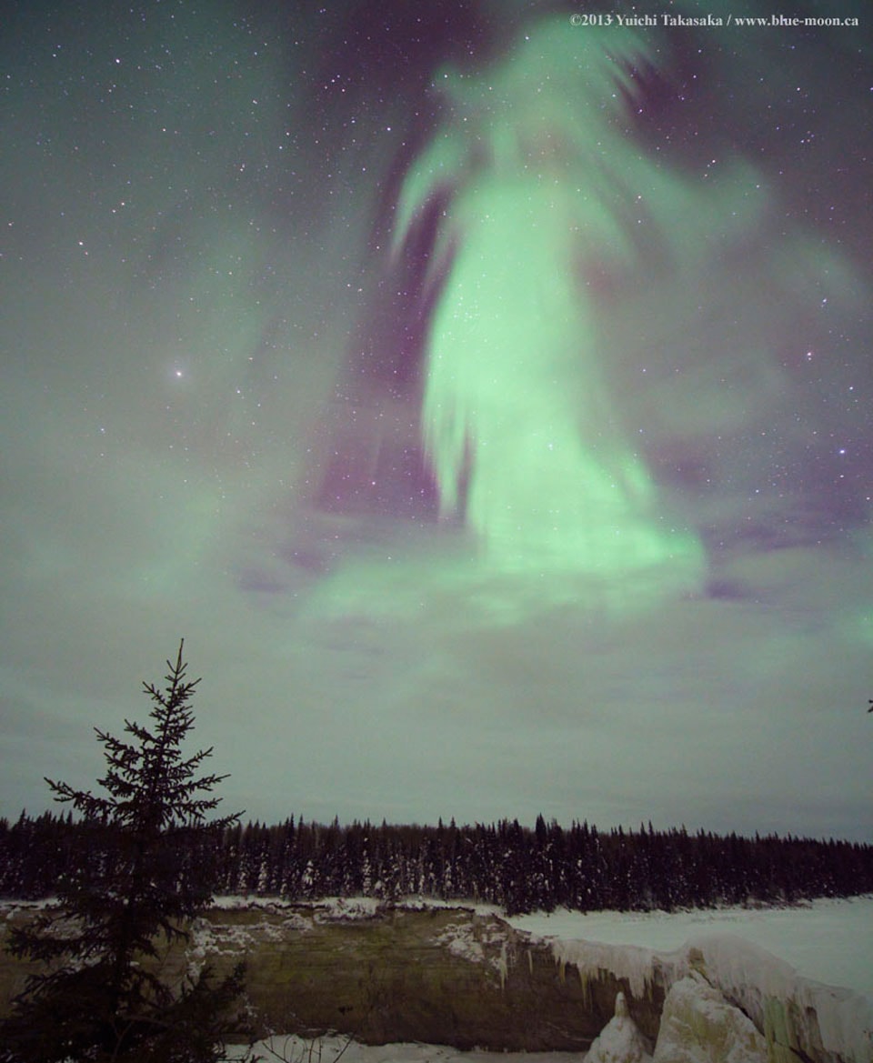 What does this aurora look like to you? While braving the cold to watch the skies above northern Canada early one morning in 2013, a most unusual aurora appeared.  The aurora definitely appeared to be shaped like something, but what? Two ghostly possibilities recorded by the astrophotographer were "witch" and "goddess of dawn", but please feel free to suggest your own Halloween-enhanced impressions. Regardless of fantastical pareidolic interpretations, the pictured aurora had a typical green color and was surely caused by the scientifically commonplace action of high-energy particles from space interacting with oxygen in Earth's upper atmosphere.  In the image foreground, at the bottom, is a frozen Alexandra Falls, while evergreen trees cross the middle.   Help Wanted: Professional-astronomer level guest writers and assistant editors for APOD