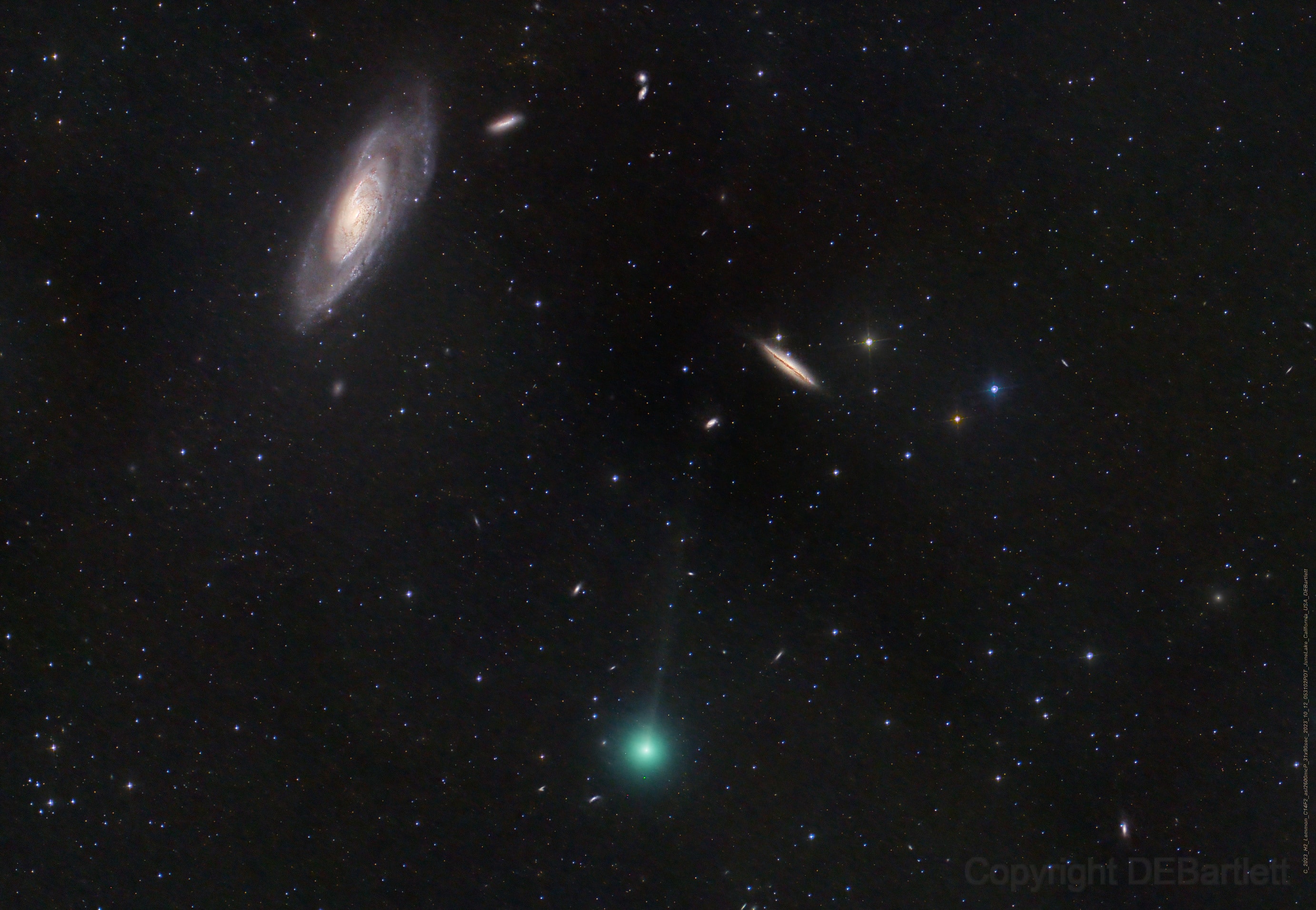 Galaxies abound in this sharp telescopic image recorded on October 12 in dark skies over June Lake, California. The celestial scene spans nearly 2 degrees within the boundaries of the well-trained northern constellation Canes Venatici. Prominent at the upper left 23.5 million light-years distant is big, beautiful spiral galaxy NGC 4258, known to some as Messier 106. Eye-catching edge-on spiral NGC 4217 is above and right of center about 60 million light-years away. Just passing through the pretty field of view is comet C/2023 H2 Lemmon, discovered last April in image data from the Mount Lemmon Survey. Here the comet sports more of a lime green coma though, along with a faint, narrow ion tail stretching toward the top of the frame. This visitor to the inner Solar System is presently less than 7 light-minutes away and still difficult to spot with binoculars, but it's growing brighter. Comet C/2023 H2 Lemmon will reach perihelion, its closest point to the Sun, on October 29 and perigee, its closest to our fair planet, on November 10 as it transitions from morning to evening northern skies.