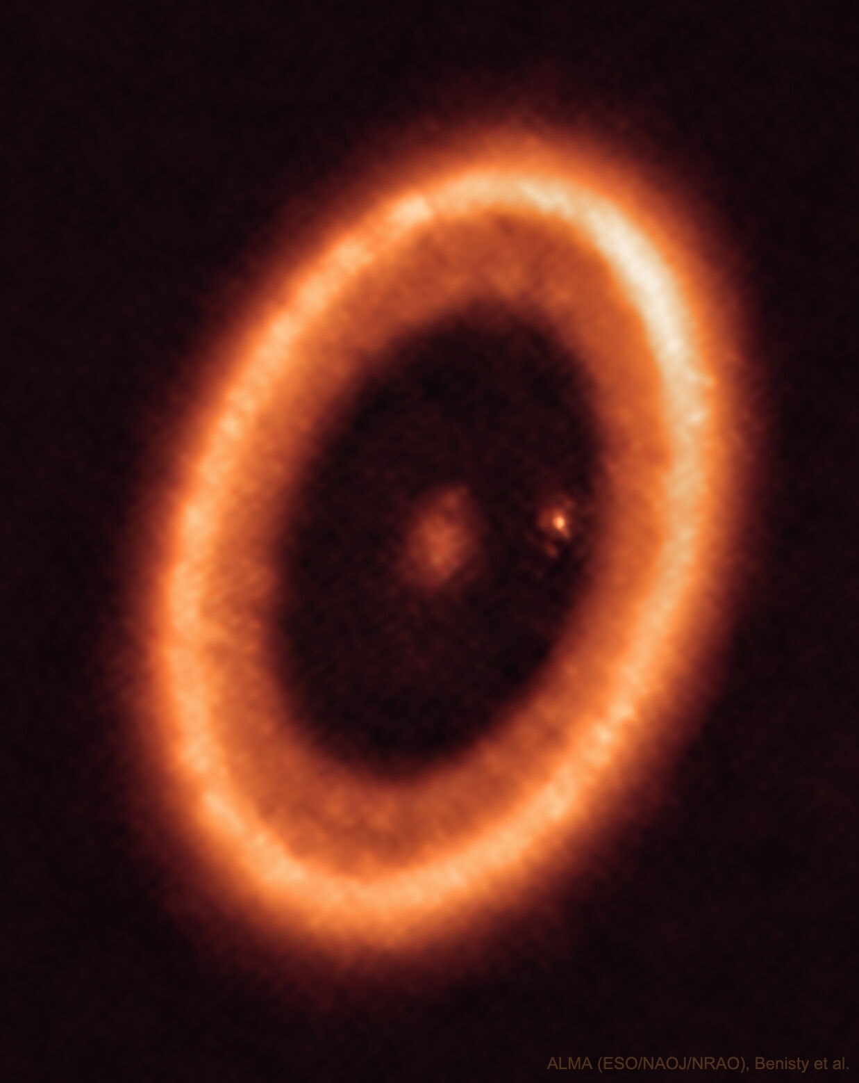 It's not the big ring that's attracting the most attention. Although the big planet-forming ring around the star PDS 70 is clearly imaged and itself quite interesting. It's also not the planet on the right, just inside the big disk, that’s being talked about the most.  Although the planet PDS 70c is a newly formed and, interestingly, similar in size and mass to Jupiter. It's the fuzzy patch around the planet PDS 70c that's causing the commotion. That fuzzy patch is thought to be a dusty disk that is now forming into moons -- and that had never been seen before. The featured image was taken in 2021 by the Atacama Large Millimeter Array (ALMA) of 66 radio telescopes in the high Atacama Desert of northern Chile.  Based on ALMA data, astronomers infer that the moon-forming exoplanetary disk has a radius similar to our Earth's orbit, and may one day form three or so Luna-sized moons -- not very different from our Jupiter's four.