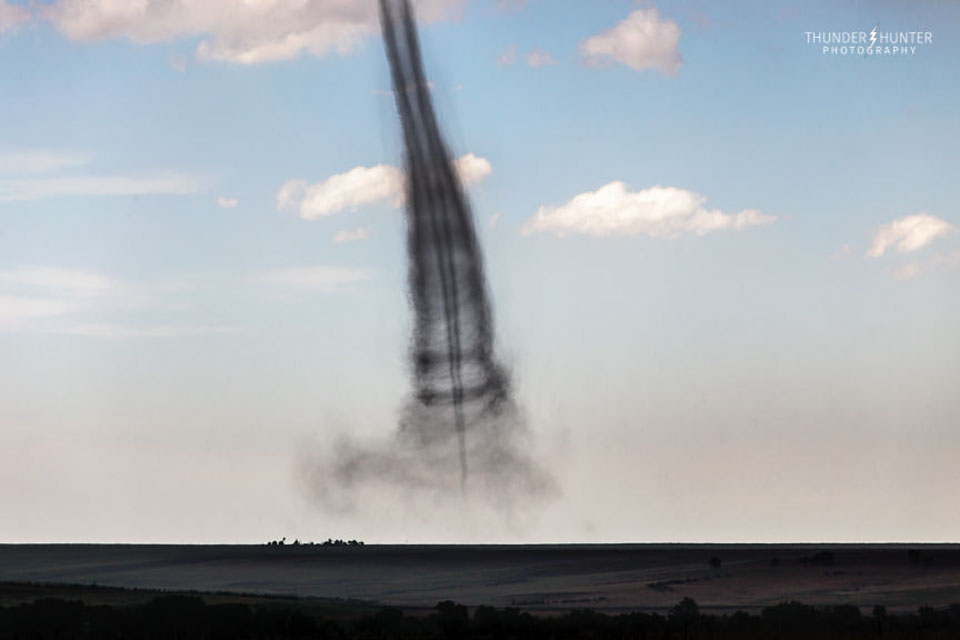 Could there be a tornado inside another tornado? In general, no.  OK, but could there be a tornado inside a wider dust devil? No again, for one reason because tornados comes down from the sky, but dust devils rise up from the ground. What is pictured is a landspout, an unusual type of tornado known to occur on the edge of a violent thunderstorm. The featured landspout was imaged and identified in Kansas, USA, in June 2019 by an experienced storm chaser.  The real tornado is in the center, and the outer sheath was possibly created by large dust particles thrown out from the central tornado. So far, the only planet known to create tornados is Earth, although tornado-like activity has been found on the Sun and dust devils are common on Mars.   Almost Hyperspace: Random APOD Generator