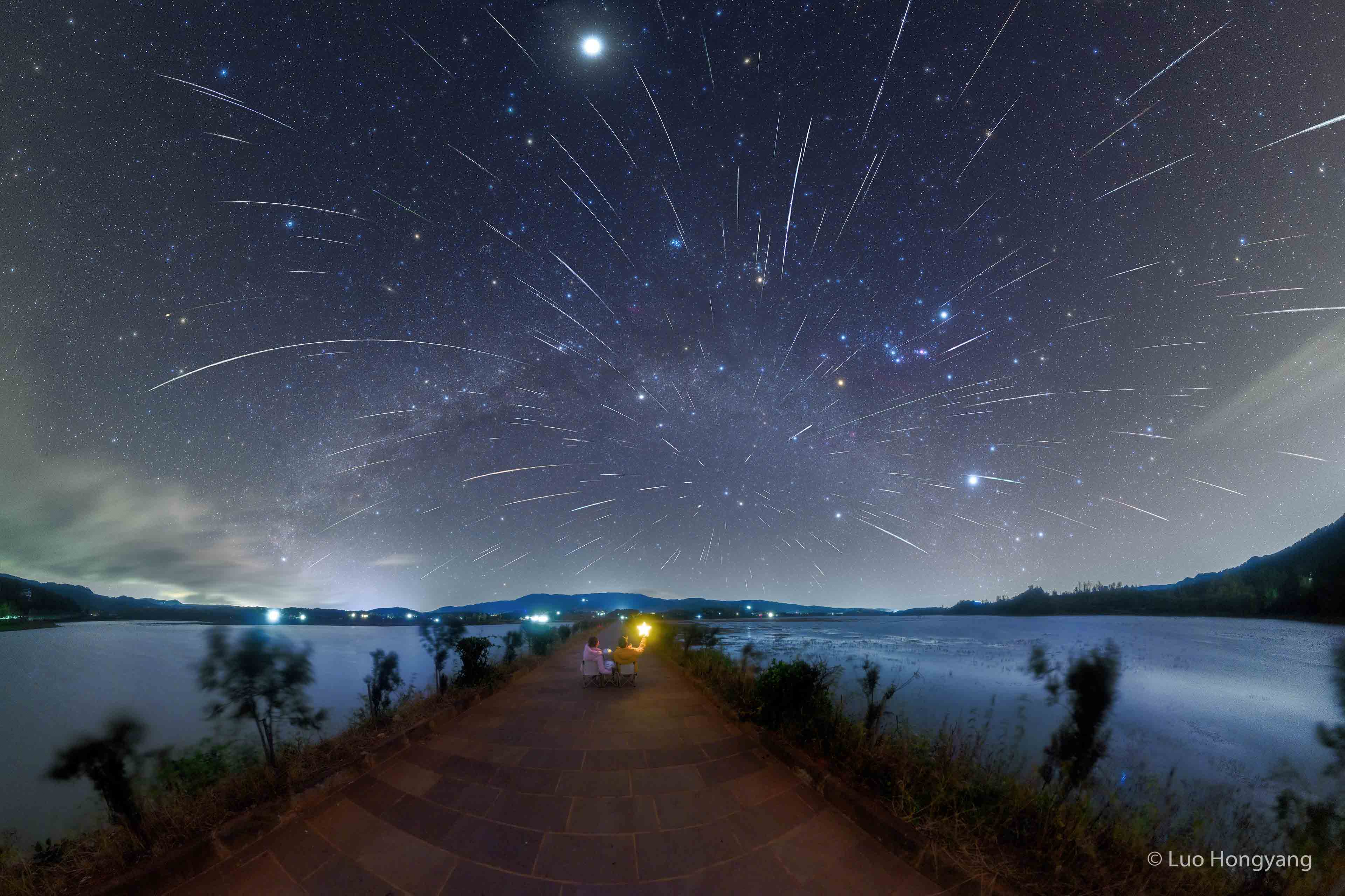 Where are all of these meteors coming from?  In terms of direction on the sky, the pointed answer is the constellation of Gemini.  That is why the major meteor shower in December is known as the Geminids -- because shower meteors all appear to come from a radiant toward Gemini. Three dimensionally, however, sand-sized debris expelled from the unusual asteroid 3200 Phaethon follows a well-defined orbit about our Sun, and the part of the orbit that approaches Earth is superposed in front of the constellation of Gemini. Therefore, when Earth crosses this orbit, the radiant point of falling debris appears in Gemini. Featured here is a composite of many images taken a few days ago through dark skies from Nianhu Lake in China. Over 100 bright meteor streaks from the Geminids meteor shower are visible.    APOD Year in Review (2023): RJN's Night Sky Network Lecture