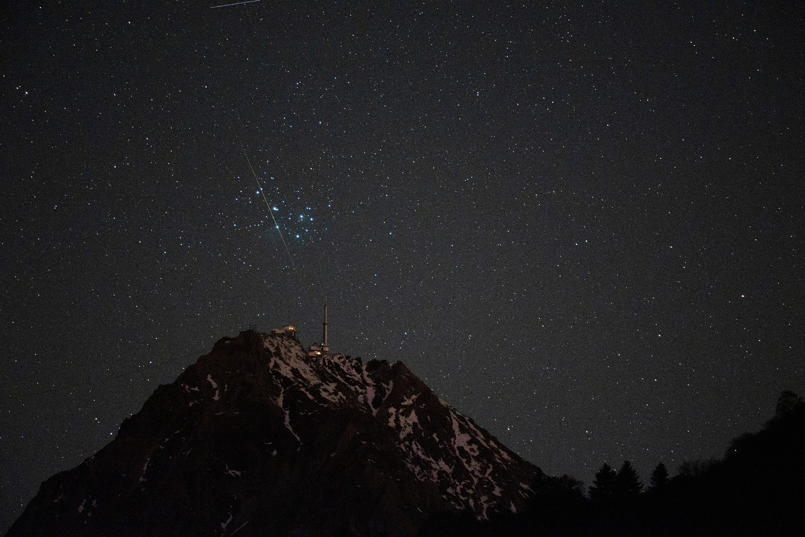 Near dawn on November 19 the Pleiades stood in still dark skies over the French Pyrenees. But just before sunrise a serendipitous moment was captured in this single 3 second exposure; a bright meteor streak appeared to pierce the heart of the galactic star cluster. From the camera's perspective, star cluster and meteor were poised directly above the mountain top observatory on the Pic du Midi de Bigorre. And though astronomers might consider the Pleiades to be relatively close by, the grain of dust vaporizing as it plowed through planet Earth's upper atmosphere actually missed the cluster's tight grouping of young stars by about 400 light-years. While recording a night sky timelapse series, the camera and telephoto lens were fixed to a tripod on the Tour-de-France-cycled slopes of the Col du Tourmalet about 5 kilometers from the Pic du Midi.