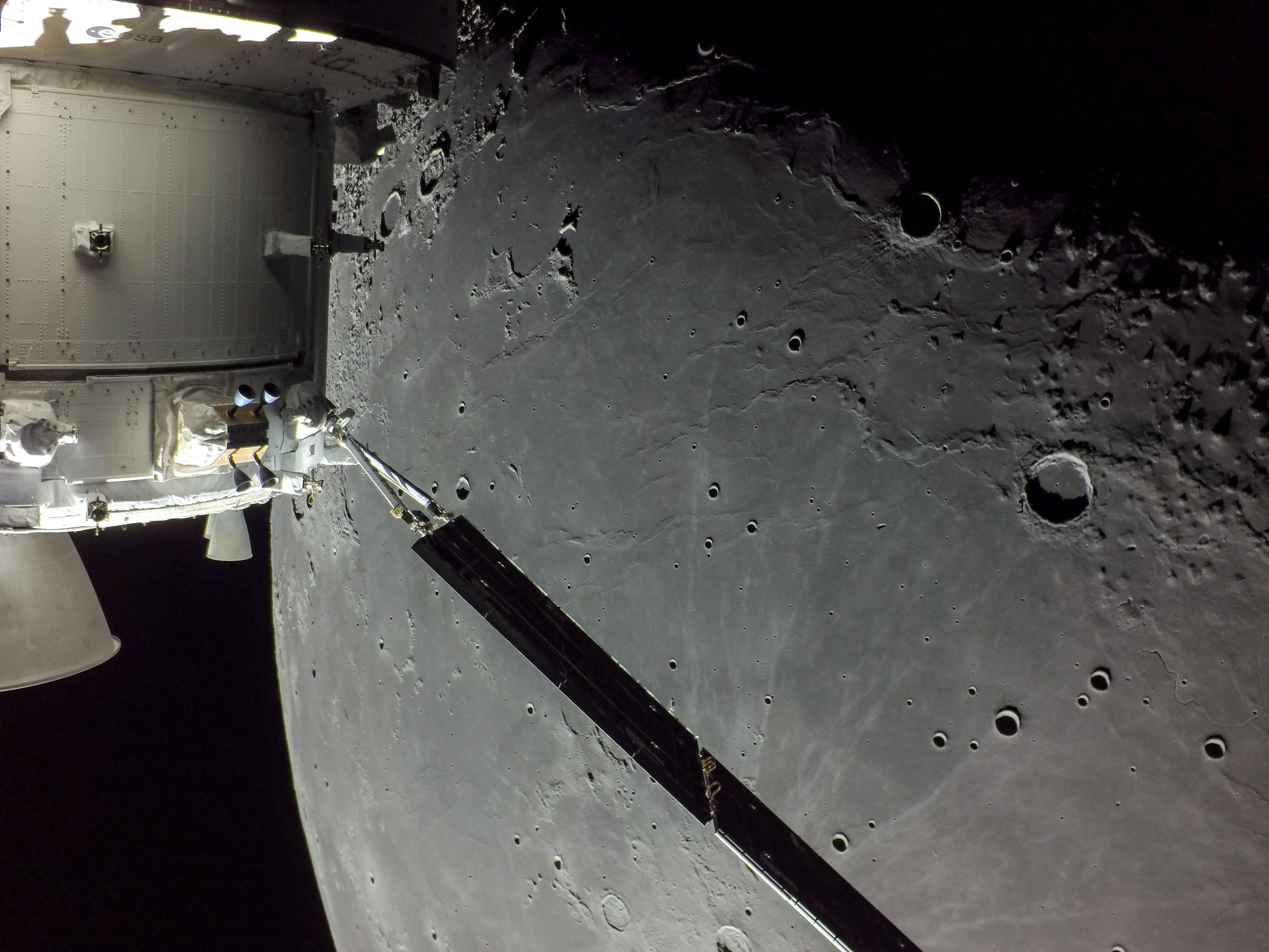 On December 5, 2022, a camera on board the uncrewed Orion spacecraft captured this view as Orion approached its return powered flyby of the Moon.  Beyond one of Orion's extended solar arrays lies dark, smooth, terrain along the western edge of the Oceanus Procellarum. Prominent on the lunar nearside Oceanus Procellarum, the Ocean of Storms, is the largest of the Moon's lava-flooded maria. The lunar terminator, shadow line between lunar night and day, runs along the left of this frame. The 41 kilometer diameter crater Marius is top center, with ray crater Kepler peeking in at the edge, just right of the solar array wing. Kepler's bright rays extend to the north and west, reaching the dark-floored Marius. By December 11, 2022 the Orion spacecraft had reached its home world. The historic Artemis 1 mission ended with Orion's successful splashdown in planet Earth's water-flooded Pacific Ocean.