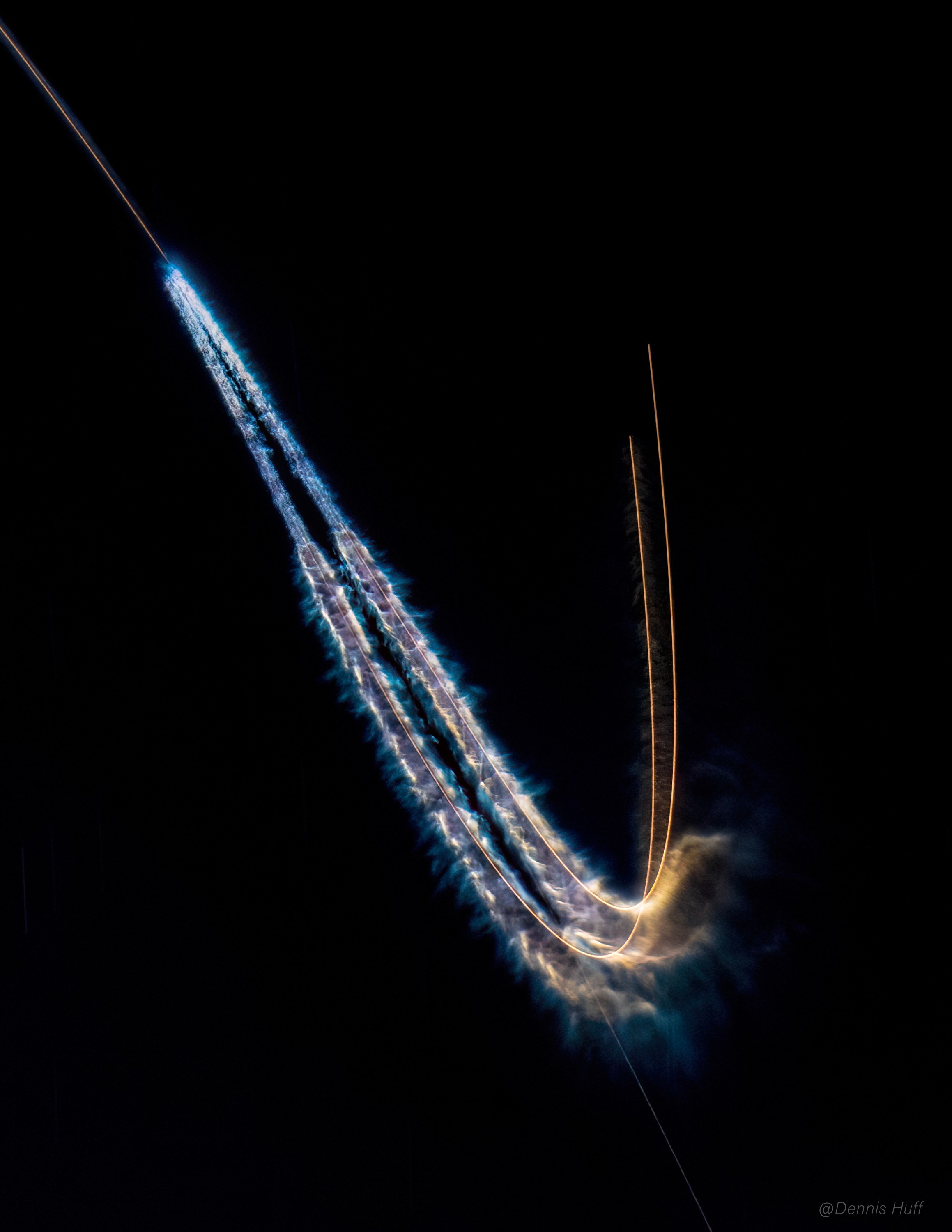 The December 28 night launch of a Falcon Heavy rocket from Kennedy Space Center in Florida marked the fifth launch for the rocket's reusable side boosters. About 2 minutes 20 seconds into the flight, the two side boosters separated from the rocket's core stage. Starting just after booster separation, this three minute long exposure captures the pair's remarkable boostback burns, maneuvers executed prior to their return to landing zones on planet Earth. While no attempt was made to recover the Falcon Heavy's core stage, both side boosters landed successfully and can be flown again. The four previous flights for these side boosters included last October's launch of NASA's asteroid-bound Psyche mission. Their next planned flight is on the Europa Clipper mission scheduled for launch in October 2024.