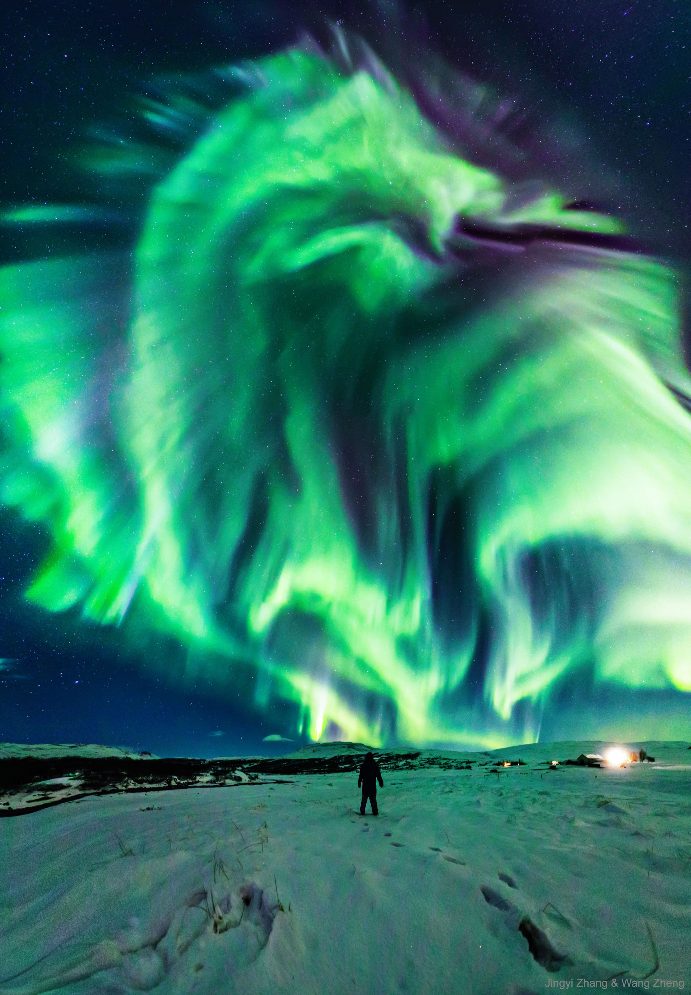 Have you ever seen a dragon in the sky? Although real flying dragons don't exist, a huge dragon-shaped aurora developed in the sky over Iceland in 2019.  The aurora was caused by a hole in the Sun's corona that expelled charged particles into a solar wind that followed a changing interplanetary magnetic field to Earth's magnetosphere.  As some of those particles then struck Earth's atmosphere, they excited atoms which subsequently emitted light: aurora. This iconic display was so enthralling that the photographer's mother ran out to see it and was captured in the foreground.  Our active Sun continues to show an unusually high number of prominences, filaments, sunspots, and large active regions as solar maximum approaches in 2025.