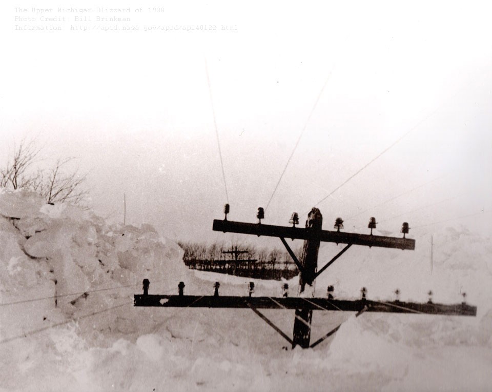 Yes, but can your blizzard do this? In the Upper Peninsula of Michigan's Storm of the Century in 1938, some snow drifts reached the level of utility poles. Nearly a meter of new and unexpected snow fell over two days in a storm that started 86 years ago this week.  As snow fell and gale-force winds piled snow to surreal heights, many roads became not only impassable but unplowable; people became stranded, cars, school buses and a train became mired, and even a dangerous fire raged. Two people were killed and some students were forced to spend several consecutive days at school.  The featured image was taken by a local resident soon after the storm. Although all of this snow eventually melted, repeated snow storms like this help build lasting glaciers in snowy regions of our planet Earth.