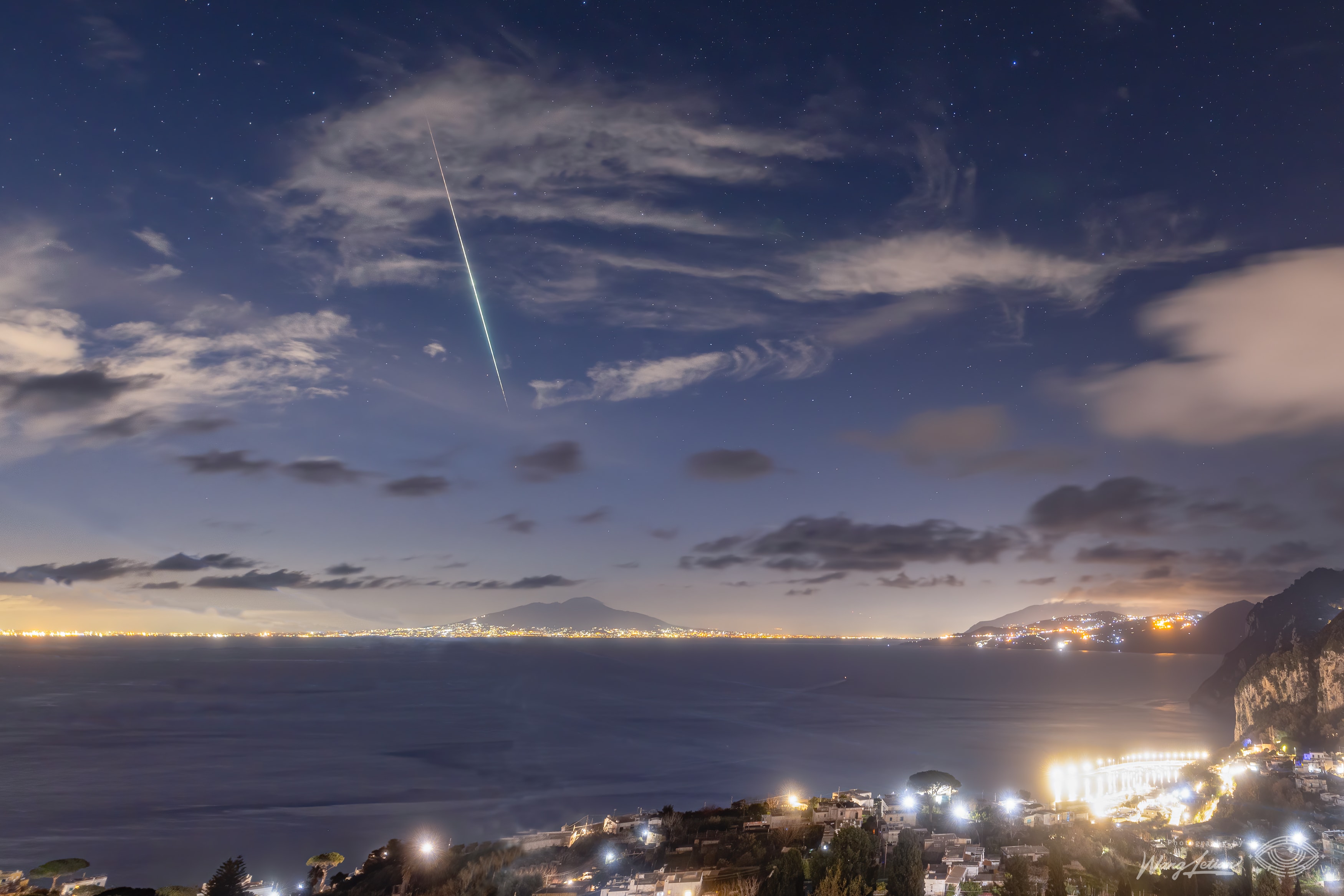 A cosmic dust grain plowing through the upper atmosphere much faster than a falling leaf created this brilliant meteor streak. In a serendipitous moment, the sublime night sky view was captured from the resort island of Capri, in the Bay of Naples, on the evening of February 8. Looking across the bay, the camera faces northeast toward the lights of Naples and surrounding cities. Pointing toward the horizon, the meteor streak by chance ends above the silhouette of Mount Vesuvius. One of planet Earth's most famous volcanos, an eruption of Mount Vesuvius destroyed the city of Pompeii in 79 AD.