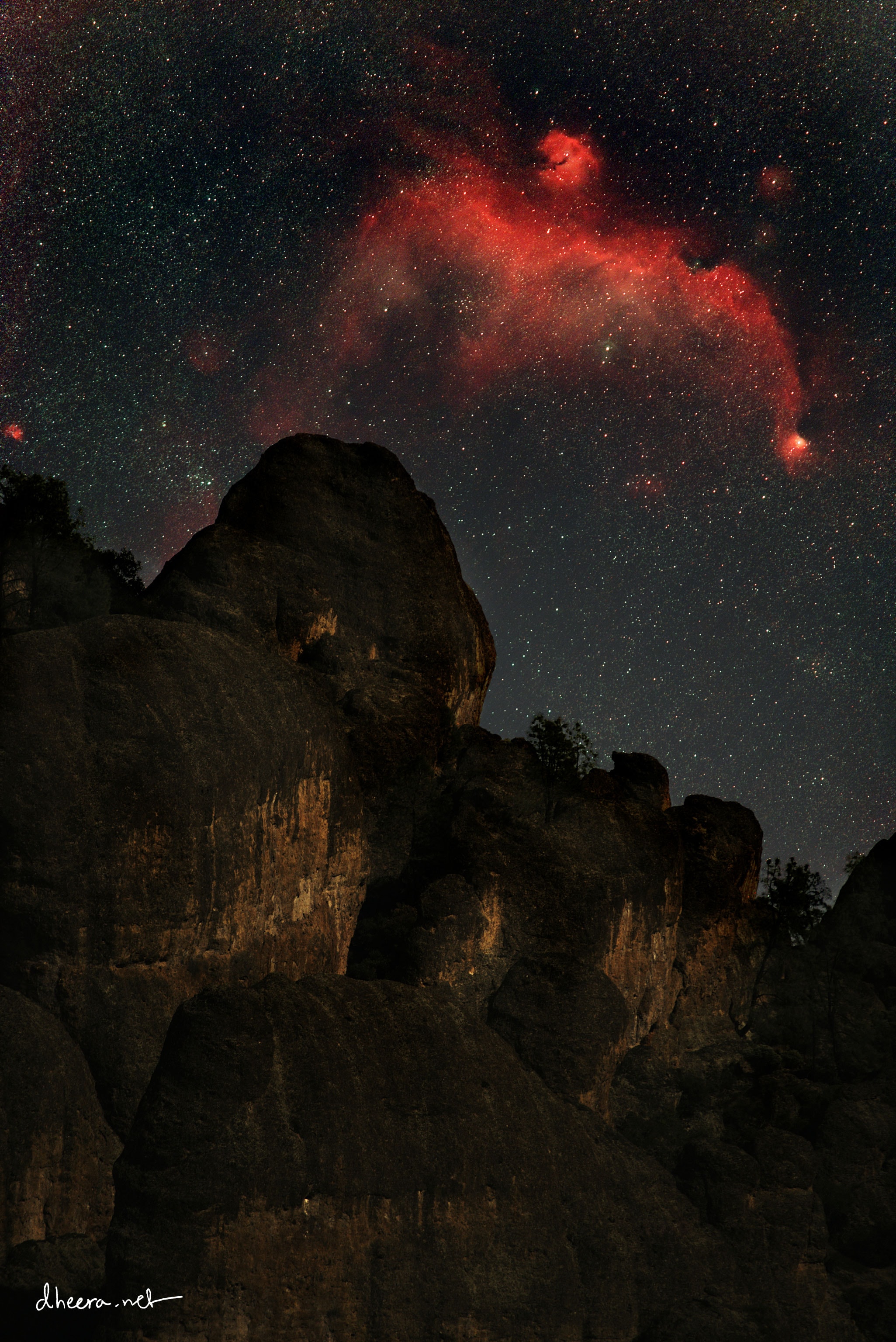 The bird is bigger than the peak.  Nicknamed for its avian shape, the Seagull Nebula is an emission nebula on the night sky that is vast, spanning an angle over five times the diameter of the full moon and over 200 light years.  The head of the nebula is catalogued as IC 2177, and the star cluster under its right wing is catalogued as NGC 2343. Consisting of mostly red-glowing hydrogen gas, the Seagull Nebula incorporates some dust lanes and is forming stars.  The peak over which this Seagull seems to soar occurs at Pinnacles National Park in California, USA.  The featured image is a composite of long exposure images of the background sky and short exposure images of the foreground, all taken consecutively with the same camera and from the same location.    Explore Your Universe: Random APOD Generator