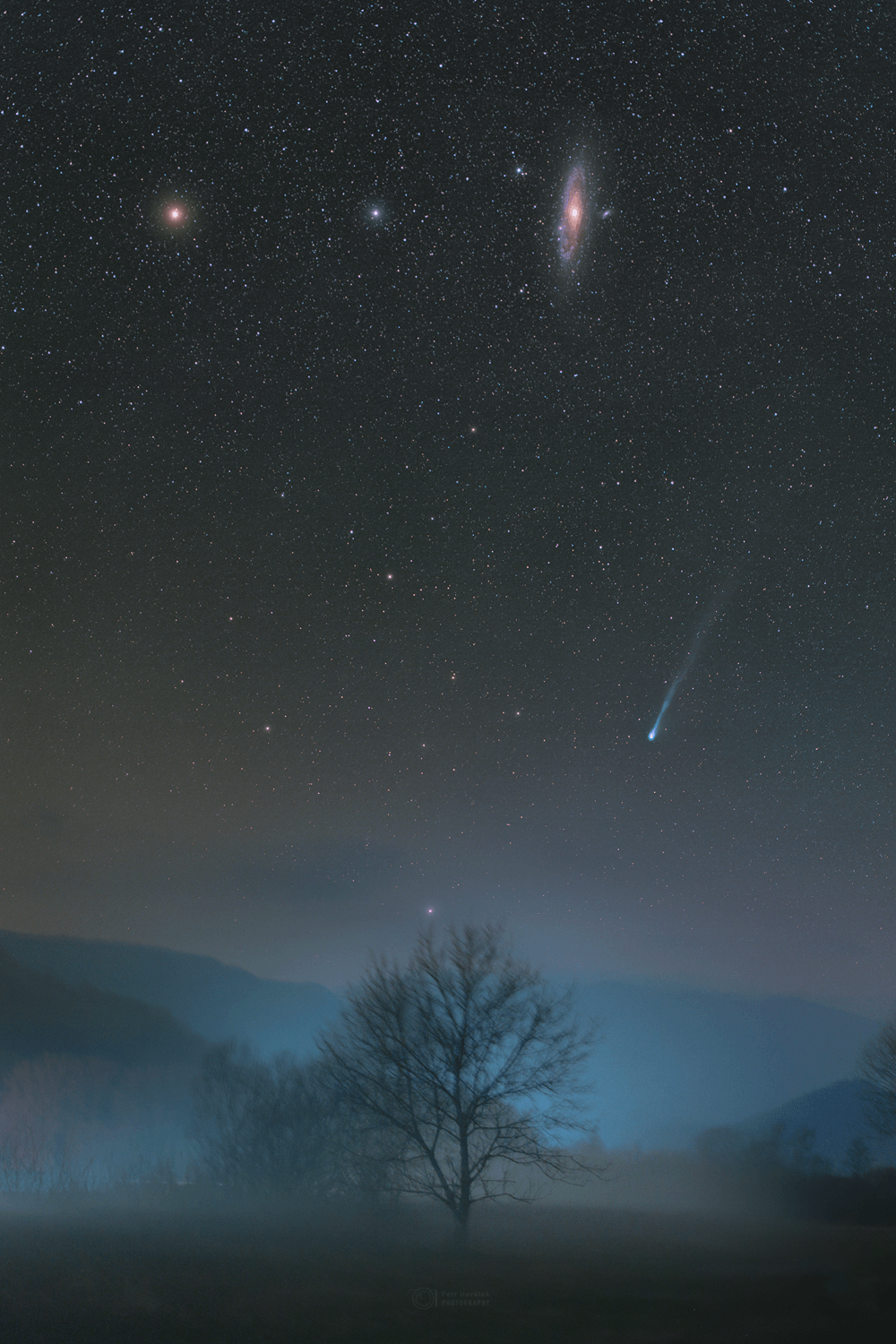 As spring approaches for northern skygazers, Comet 12P/Pons-Brooks is growing brighter. Currently visible with small telescopes and binoculars, the Halley-type comet could reach naked eye visibility in the coming weeks. Seen despite a foggy atmosphere, the comet's green coma and long tail hover near the horizon in this well-composed deep night skyscape from Revuca, Slovakia recorded on March 5. M31, also known as the Andromeda galaxy, and bright yellowish star Mirach, beta star of the constellation Andromeda, hang in the sky above the comet. The Andromeda galaxy is some 2.5 million light-years beyond the Milky Way. Comet Pons-Brooks is a periodic visitor to the inner Solar System and less than 14 light-minutes away. Reaching its perihelion on April 21, this comet should be visible in the sky during the April 8 total solar eclipse.