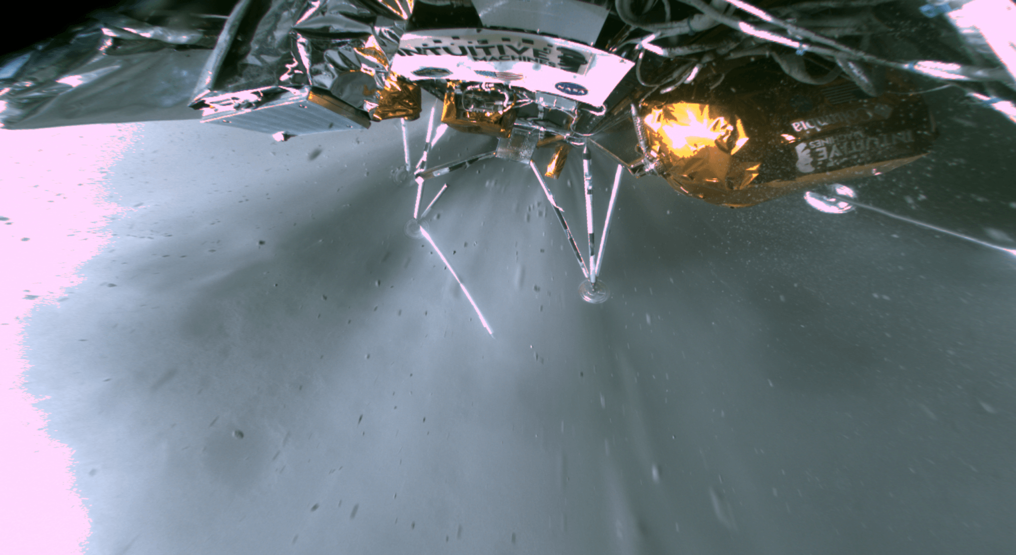 Methalox rocket engine firing, Odysseus' landing legs absorb first contact with the lunar surface in this wide-angle snapshot from a camera on board the robotic Intuitive Machines Nova-C moon lander. Following the landing on February 22, broken landing legs, visible in the image, ultimately left the lander at rest but tilted. Odysseus' gentle lean into a sloping lunar surface preserved the phone booth-sized lander's ability to operate, collect solar power, and return images and data to Earth. Its exact landing site in the Moon's far south polar region was imaged by NASA's Lunar Reconnaissance Orbiter. Donated by NASA, the American flag seen on the lander's central panel is 1970 Apollo program flight hardware.