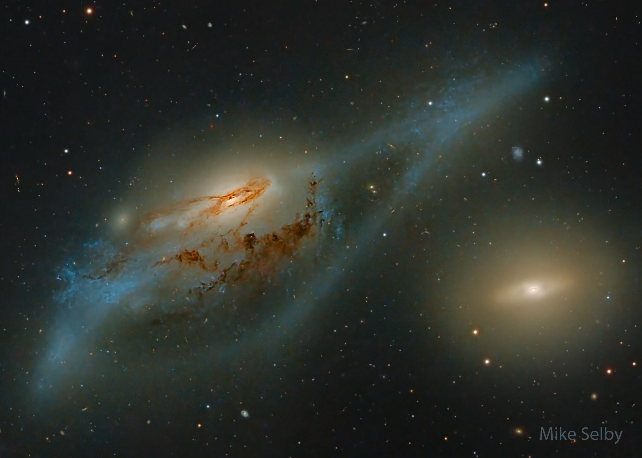 Across the heart of the Virgo Galaxy Cluster lies a string of galaxies known as Markarian's Chain. Prominent in Markarian's Chain are these two interacting galaxies, NGC 4438 (left) and NGC 4435 - also known as The Eyes. About 50 million light-years away, the two galaxies appear to be about 100,000 light-years apart in this sharp close-up, but have likely approached to within an estimated 16,000 light-years of each other in their cosmic past. Gravitational tides from the close encounter have ripped away at their stars, gas, and dust. The more massive NGC 4438 managed to hold on to much of the material torn out in the collision, while material from the smaller NGC 4435 was more easily lost. The remarkably deep image of this crowded region of the universe also includes many more distant background galaxies.