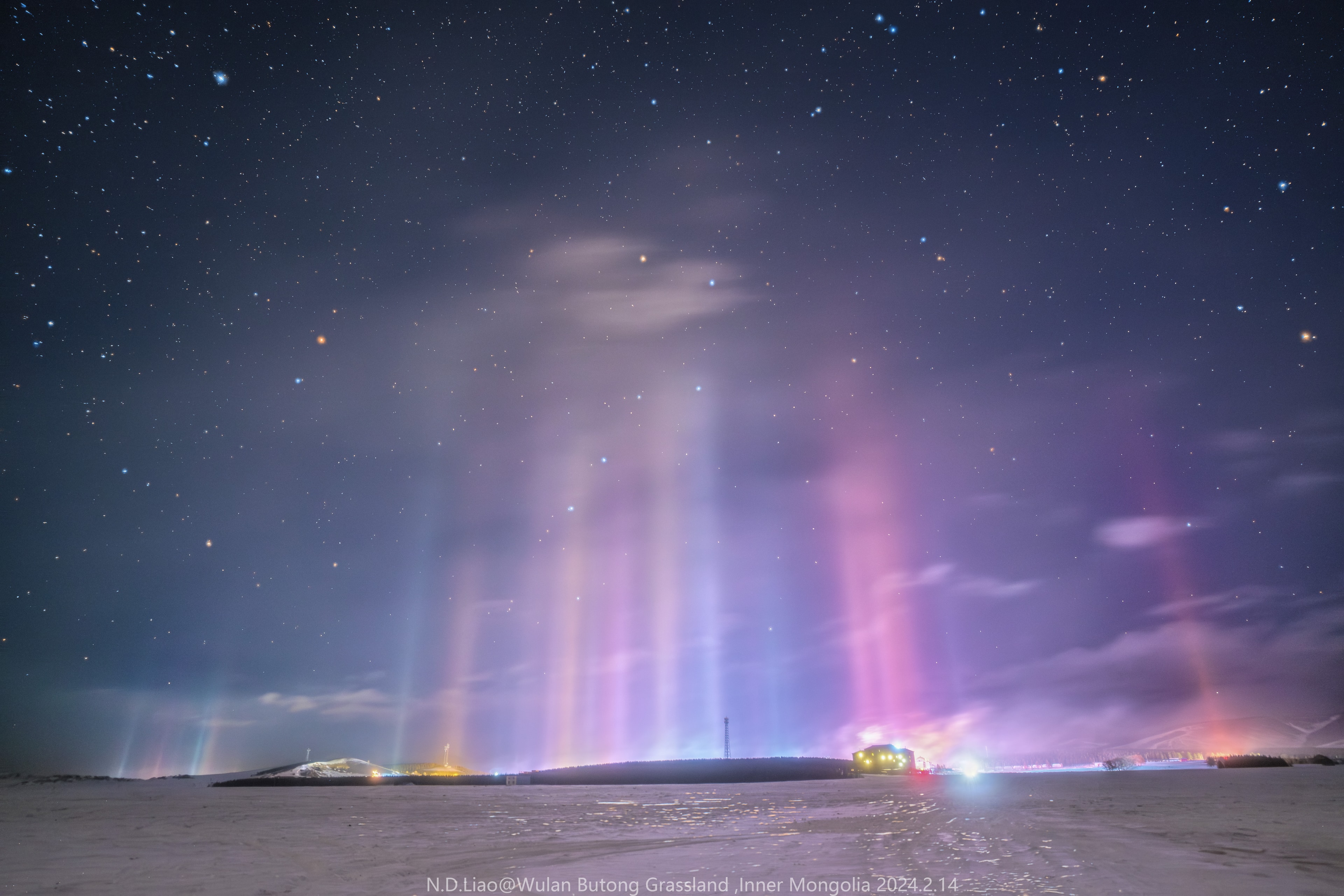 What's happening across that field?  Pictured here are not auroras but nearby light pillars, a phenomenon typically much closer.   In most places on Earth, a lucky viewer can see a Sun pillar, a column of light appearing to extend up from the Sun caused by flat fluttering ice-crystals reflecting sunlight from the upper atmosphere.  Usually, these ice crystals evaporate before reaching the ground.  During freezing temperatures, however, flat fluttering ice crystals may form near the ground in a form of light snow  sometimes known as a crystal fog.  These ice crystals may then reflect ground lights in columns not unlike a Sun pillar.  The featured image was taken last month across the Wulan Butong Grasslands in Inner Mongolia, China.