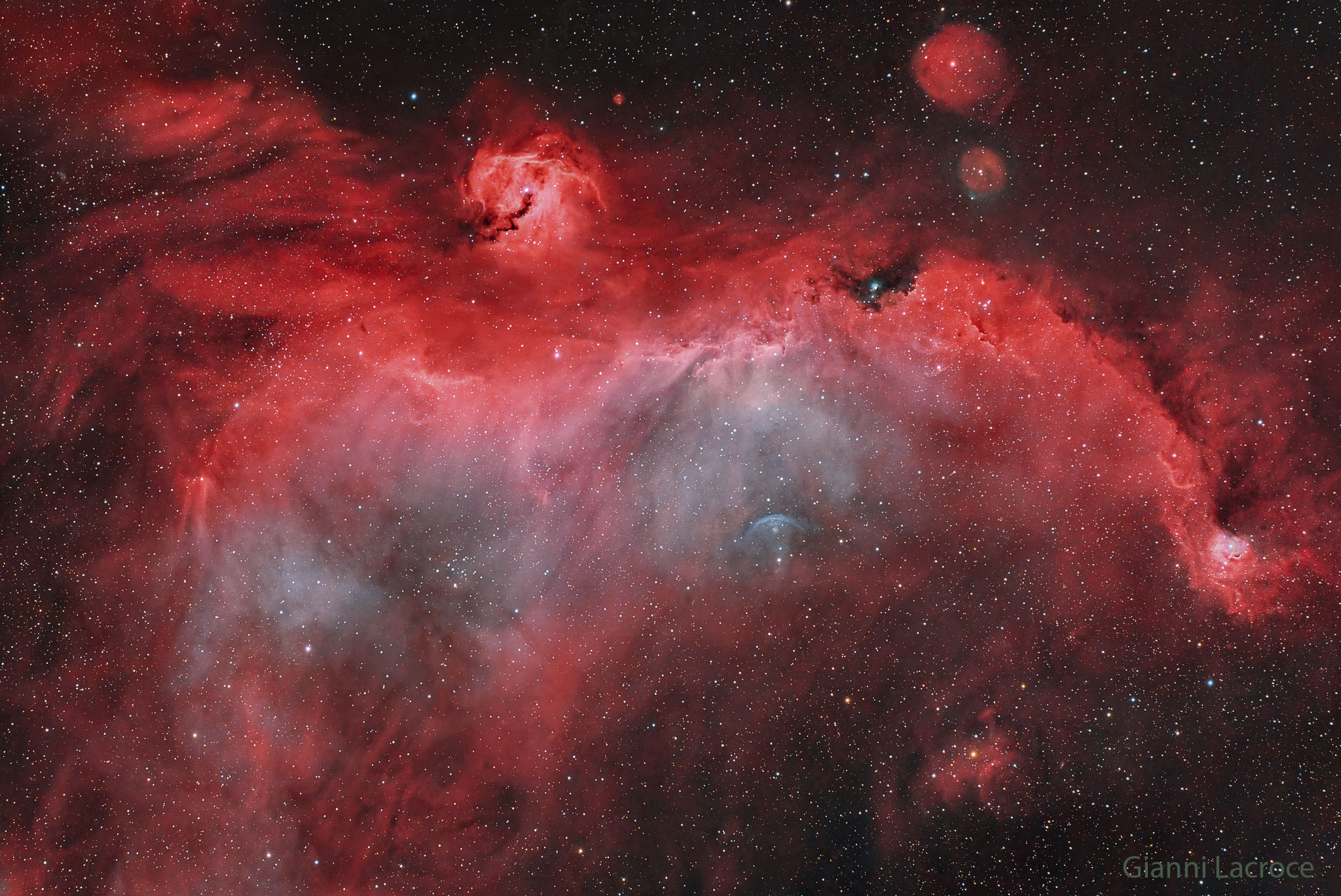 A broad expanse of glowing gas and dust presents a bird-like visage to astronomers from planet Earth, suggesting its popular moniker: the Seagull Nebula. This portrait of the cosmic bird covers a 2.5-degree wide swath across the plane of the Milky Way, near the direction of Sirius, alpha star of the constellation of the Big Dog (Canis Major). Of course, the region includes objects with other catalog designations: notably NGC 2327, a compact, dusty emission and reflection nebula with an embedded massive star that forms the bird's head. Likely part of a larger shell structure swept up by successive supernova explosions, the broad Seagull Nebula is cataloged as Sh2-296 and IC 2177. The prominent bluish arc below and right of center is a bow shock from runaway star FN Canis Majoris. Dominated by the reddish glow of atomic hydrogen, this complex of gas and dust clouds with other stars of the Canis Majoris OB1 association spans over 200 light-years at the Seagull Nebula's estimated 3,800 light-year distance.   Almost Hyperspace: Random APOD Generator