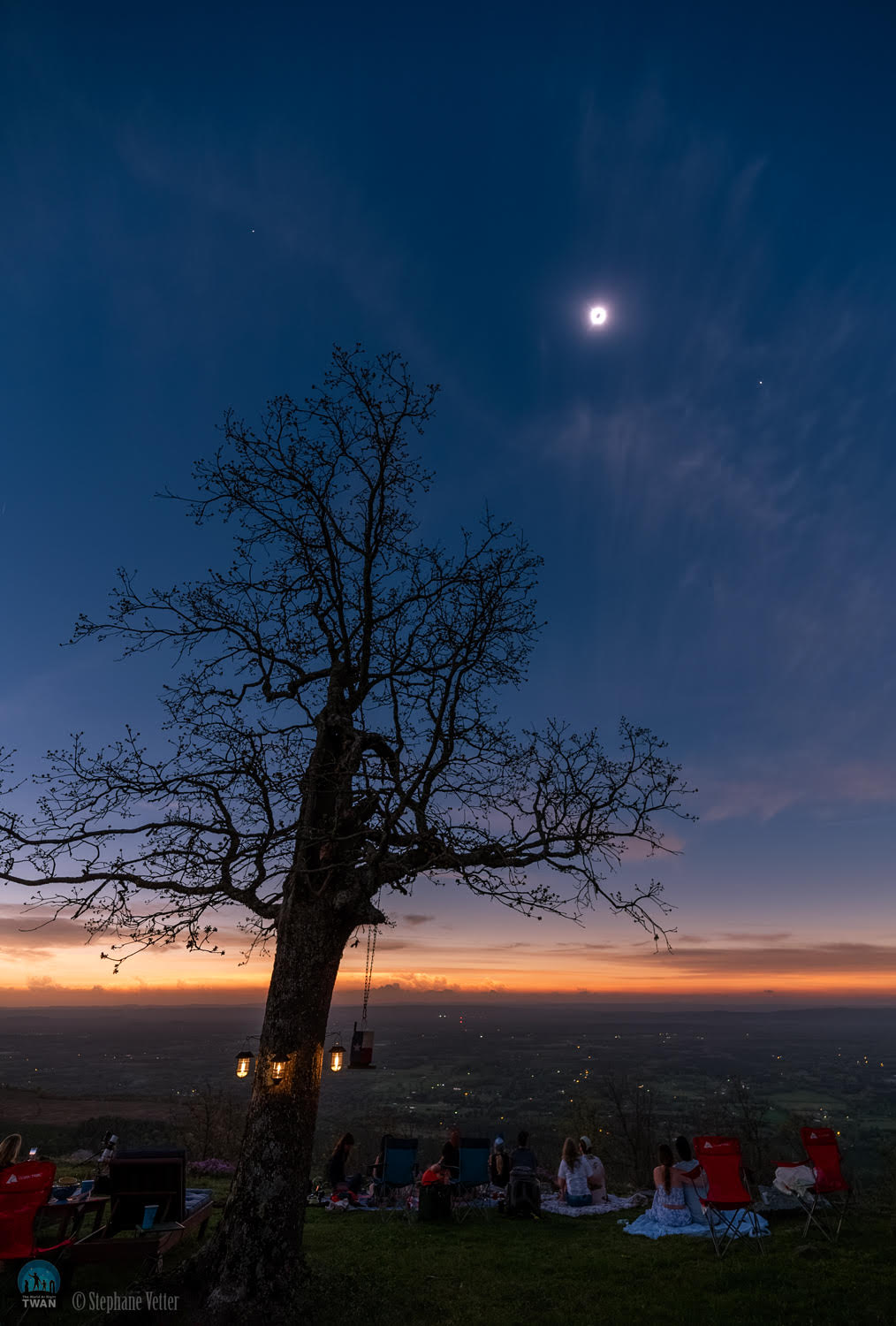 What wonders appear when the Moon blocks the Sun? For many eager observers of Monday’s total eclipse of the Sun, the suddenly dark sky included the expected corona and two (perhaps surprise) planets: Venus and Jupiter. Normally, in recent days, Venus is visible only in the morning when the Sun and Jupiter are below the horizon, while Jupiter appears bright only in the evening.  On Monday, though, for well-placed observers, both planets became easily visible during the day right in line with the totally eclipsed Sun. This line was captured Monday afternoon in the featured image from Mount Nebo, Arkansas, USA, along with a line of curious observers — and a picturesque tree.   Monday's Eclipse Imagery: Notable Submissions to APOD