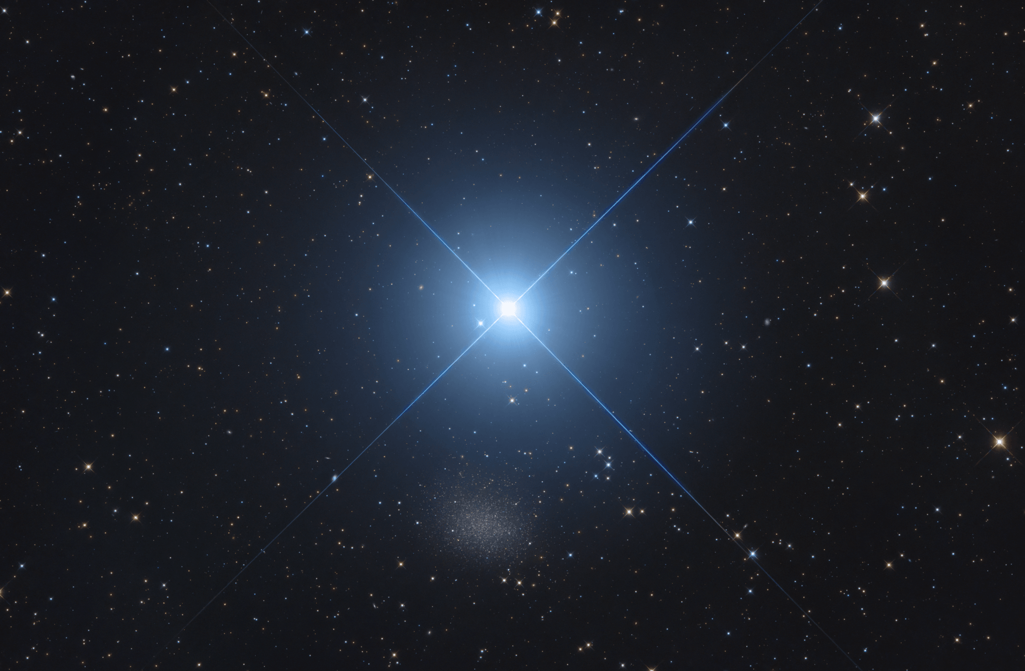 In northern hemisphere spring, bright star Regulus is easy to spot above the eastern horizon. The alpha star of the constellation Leo, Regulus is the spiky star centered in this telescopic field of view. A mere 79 light-years distant, Regulus is a hot, rapidly spinning star that is known to be part of a multiple star system. Not quite lost in the glare, the fuzzy patch just below Regulus is diffuse starlight from small galaxy Leo I. Leo I is a dwarf spheroidal galaxy, a member of the Local Group of galaxies dominated by our Milky Way Galaxy and the Andromeda Galaxy (M31). About 800 thousand light-years away, Leo I is thought to be the most distant of the known small satellite galaxies orbiting the Milky Way. But dwarf galaxy Leo I has shown evidence of a supermassive black hole at its center, comparable in mass to the black hole at the center of the Milky Way.