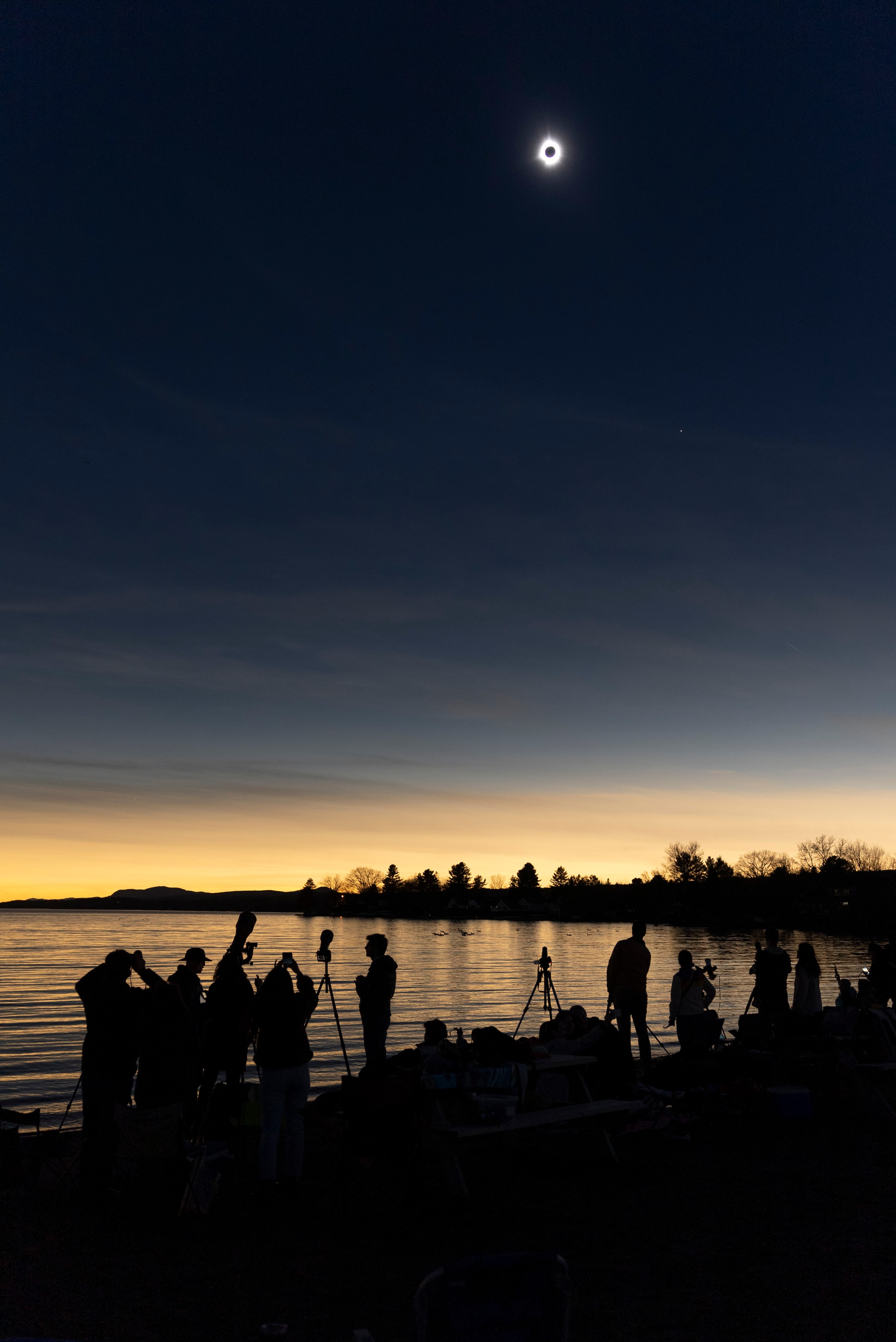 Captured in this snapshot, the shadow of the Moon came to Lake Magog, Quebec, North America, planet Earth on April 8. For the lakeside eclipse chasers, the much anticipated total solar eclipse was a spectacle to behold in briefly dark, but clear skies. Of course Lake Magog was one of the last places to be visited by the Moon's shadow. The narrow path of totality for the 2024 total solar eclipse swept from Mexico's Pacific Coast north and eastward through the US and Canada. But a partial eclipse was visible across most of the North American continent.   Total Eclipse Imagery: Notable Submissions to APOD