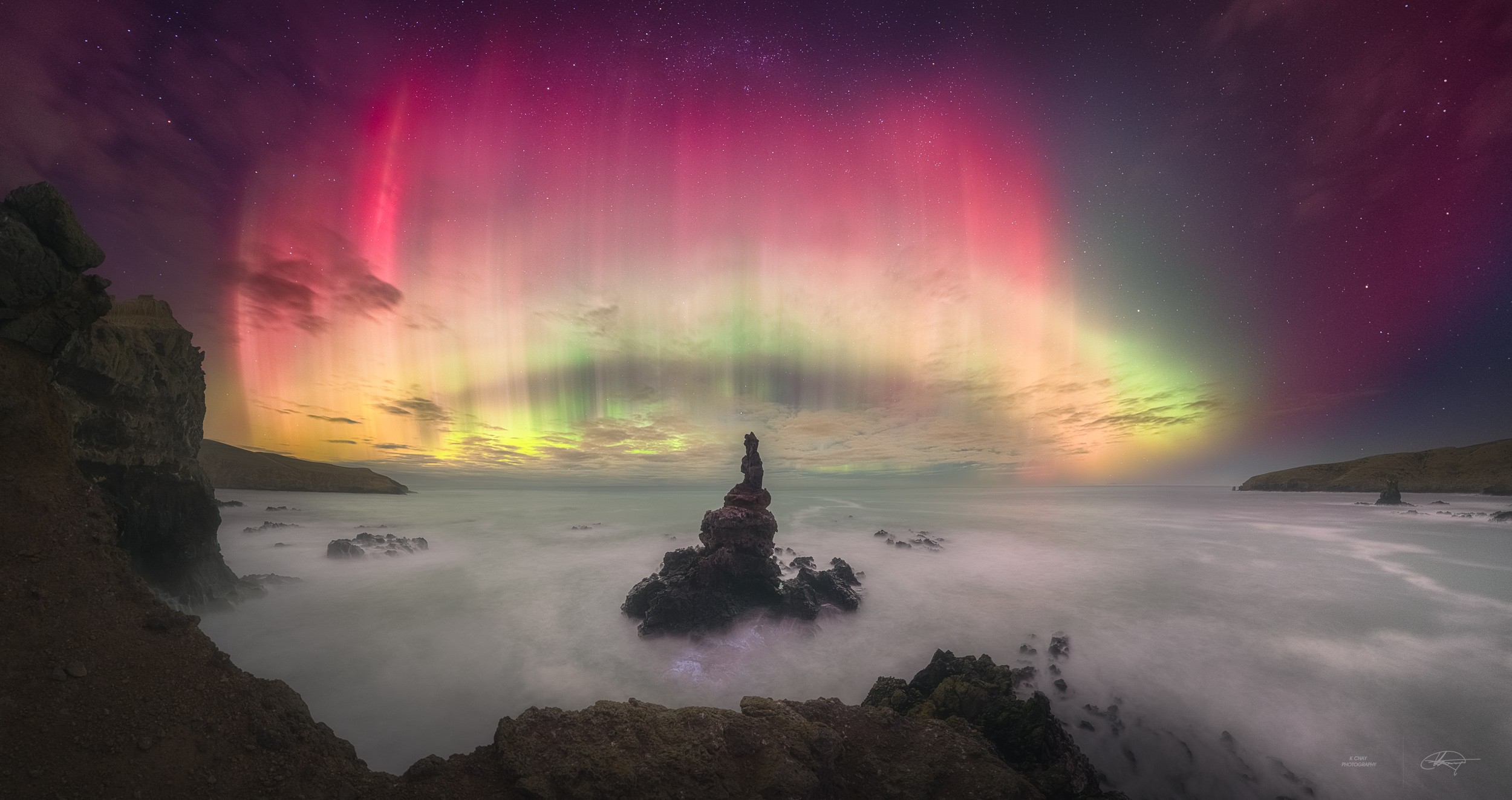 This well-composed composite panoramic view looks due south from Banks Peninsula near Christchurch on New Zealand's South Island. The base of a tower-like rocky sea stack is awash in the foreground, with stars of the Southern Cross at the top of the frame and planet Earth's south celestial pole near center. Still, captured on May 11, vibrant aurora australis dominate the starry southern sea and skyscape. The shimmering southern lights were part of extensive auroral displays that entertained skywatchers in northern and southern hemispheres around planet Earth, caused by intense geomagnetic storms. The extreme spaceweather was triggered by the impact of coronal mass ejections launched from powerful solar active region AR 3664.   AuroraSaurus: Report your aurora observations