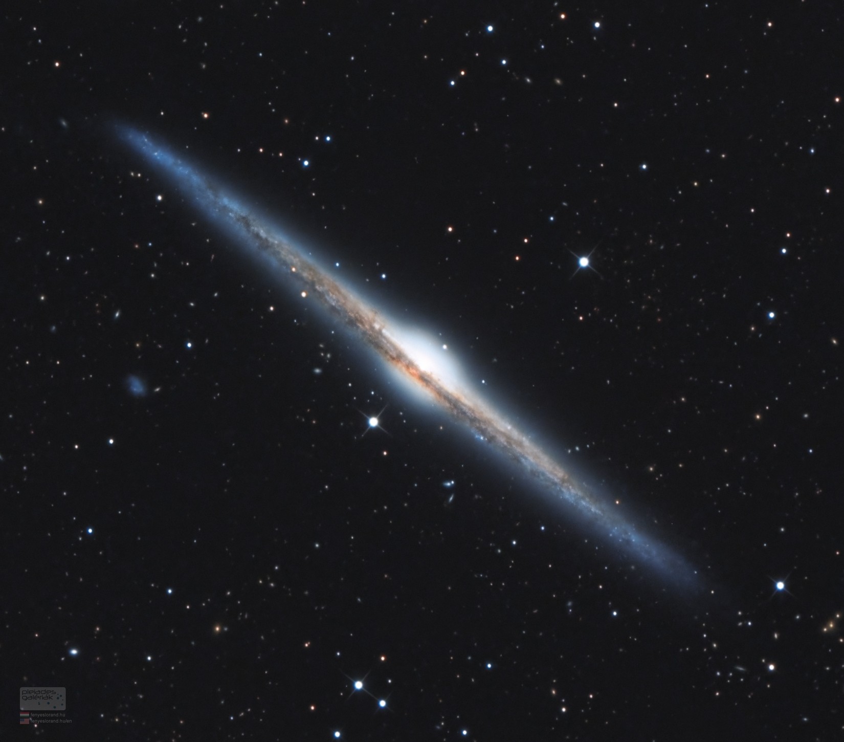 Magnificent spiral galaxy NGC 4565 is viewed edge-on from planet Earth. Also known as the Needle Galaxy for its narrow profile, bright NGC 4565 is a stop on many telescopic tours of the northern sky, in the faint but well-groomed constellation Coma Berenices. This sharp, colorful image reveals the galaxy's boxy, bulging central core cut by obscuring dust lanes that lace NGC 4565's thin galactic plane. NGC 4565 itself lies about 40 million light-years distant and spans some 100,000 light-years.  Easily spotted with small telescopes, sky enthusiasts consider NGC 4565 to be a prominent celestial masterpiece Messier missed.