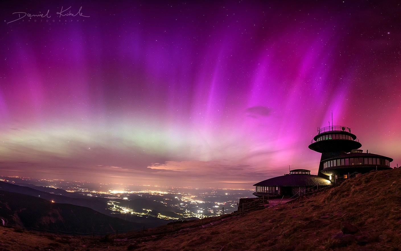 It was the first time ever. At least, the first time this photographer had ever seen aurora from his home mountains.  And what a spectacular aurora it was. The Karkonosze Mountains in Poland are usually too far south to see any auroras.  But on the amazing night of May 10 - 11, purple and green colors lit up much of the night sky, a surprising spectacle that  also appeared over many mid-latitude locations around the Earth.  The featured image is a composite of six vertical exposures taken during the auroral peak. The futuristic buildings on the right are part of a meteorological observatory located on the highest peak of the Karkonosze Mountains.  The purple color is primarily due to Sun-triggered, high-energy electrons impacting nitrogen molecules in Earth's atmosphere.  Our Sun is reaching its maximum surface activity over the next two years, and although many more auroras are predicted, most will occur over regions closer to the Earth's poles.