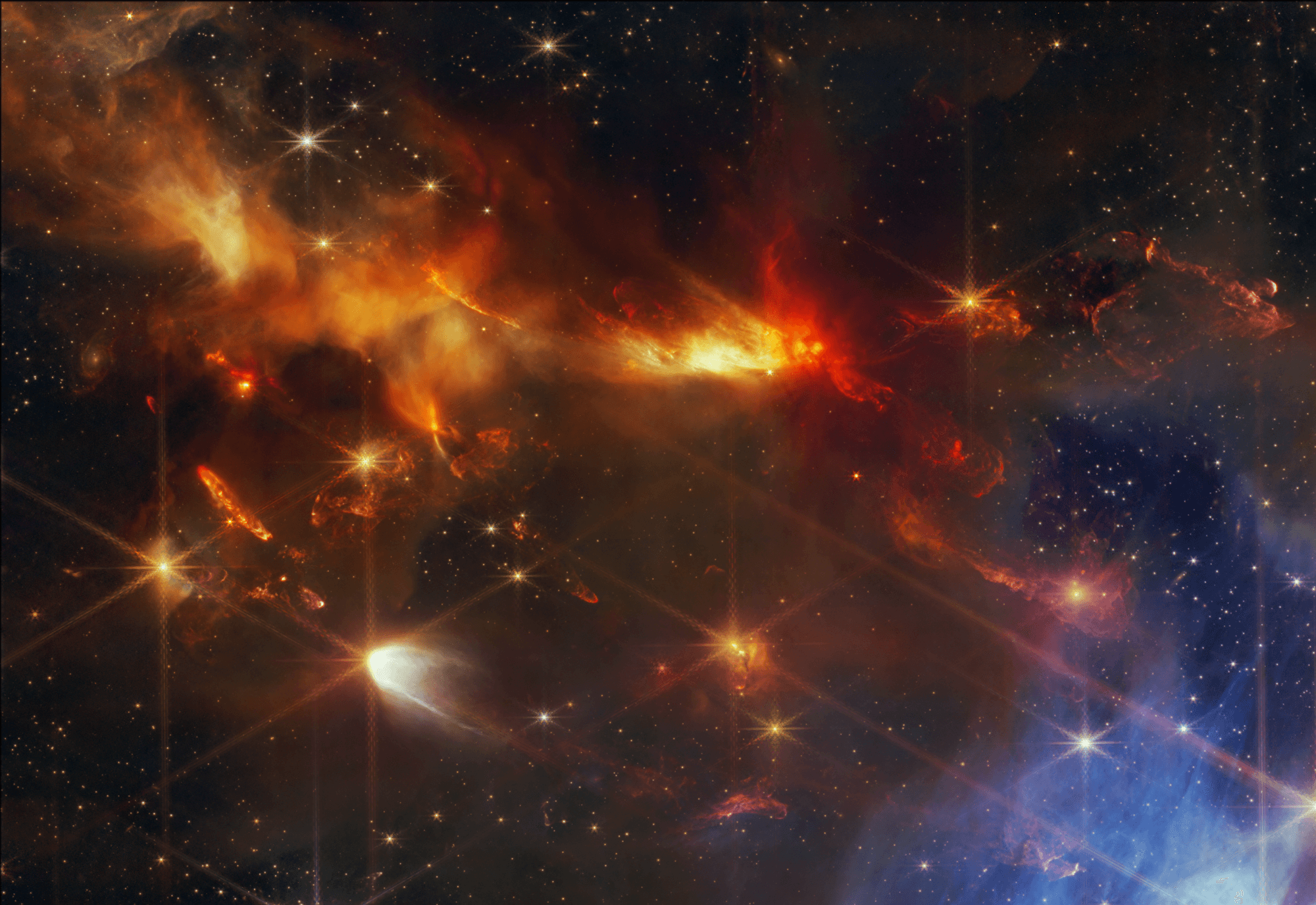 Jets of material blasting from newborn stars, are captured in this James Webb Space Telescope close-up of the Serpens Nebula. The powerful protostellar outflows are bipolar, twin jets spewing in opposite directions. Their directions are perpendicular to accretion disks formed around the spinning, collapsing stellar infants. In the NIRcam image, the reddish color represents emission from molecular hydrogen and carbon monoxide produced as the jets collide with the surrounding gas and dust. The sharp image shows for the first time that individual outflows detected in the Serpens Nebula are generally aligned along the same direction. That result was expected, but has only now come into clear view with Webb's detailed exploration of the active young star-forming region. Brighter foreground stars exhibit Webb's characteristic diffraction spikes. At the Serpens Nebula's estimated distance of 1,300 light-years, this cosmic close-up frame is about 1 light-year across.