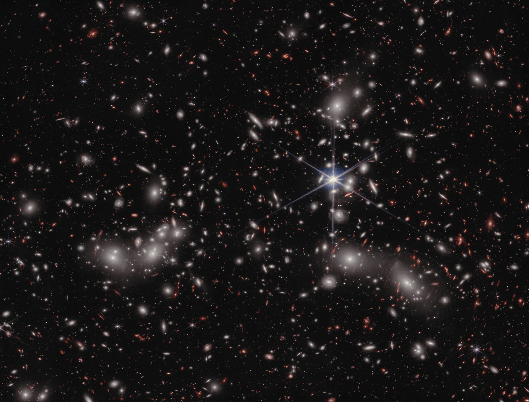 This deep field mosaicked image presents a stunning view of galaxy cluster Abell 2744 recorded by the James Webb Space Telescope's NIRCam. Also dubbed Pandora's Cluster, Abell 2744 itself appears to be a ponderous merger of three different massive galaxy clusters. It lies some 3.5 billion light-years away, toward the constellation Sculptor. Dominated by dark matter, the mega-cluster warps and distorts the fabric of spacetime, gravitationally lensing even more distant objects. Redder than the Pandora cluster galaxies many of the lensed sources are very distant galaxies in the early Universe, their lensed images stretched and distorted into arcs. Of course distinctive diffraction spikes mark foreground Milky Way stars. At the Pandora Cluster's estimated distance this cosmic box spans about 6 million light-years. But don't panic. You can explore the tantalizing region in a 2 minute video tour.