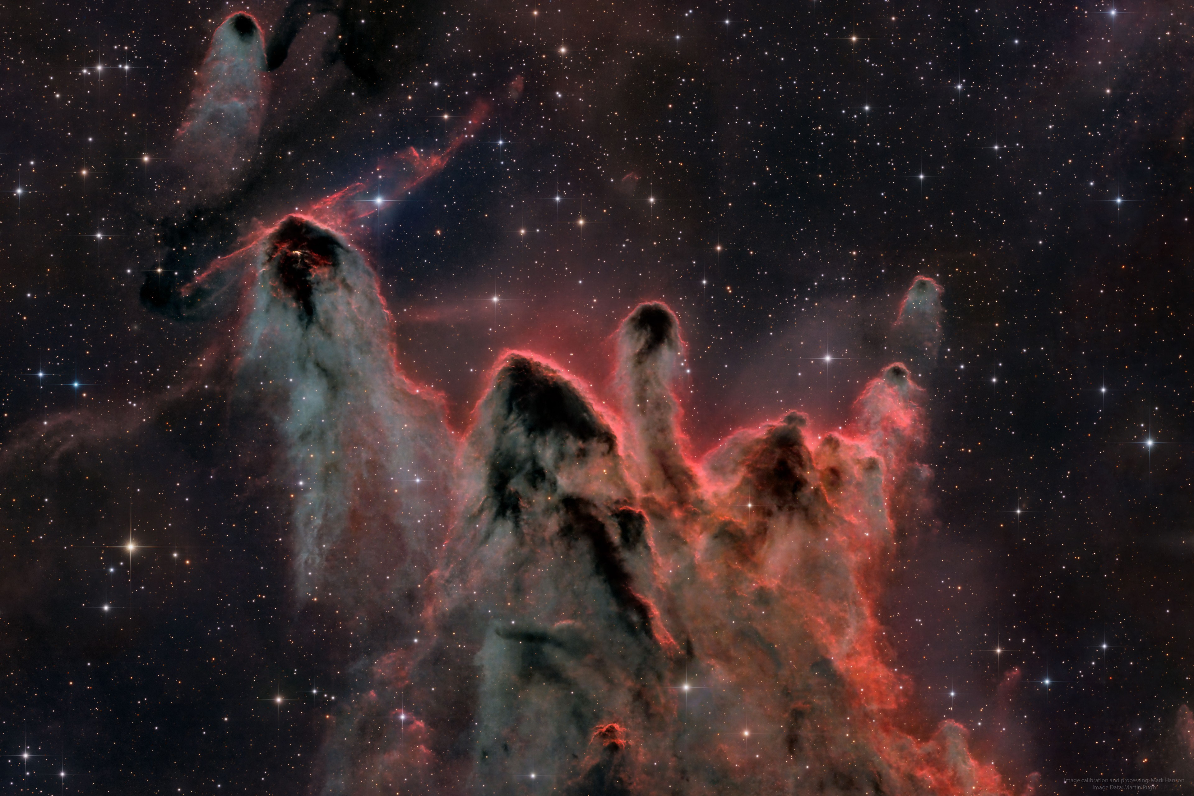 What are these unusual interstellar structures? Bright-rimmed, flowing shapes gather near the center of this rich starfield toward the borders of the nautical southern constellations Pupis and Vela. Composed of interstellar gas and dust, the grouping of light-year sized cometary globules is about 1300 light-years distant. Energetic ultraviolet light from nearby hot stars has molded the globules and ionized their bright rims. The globules also stream away from the Vela supernova remnant which may have influenced their swept-back shapes. Within them, cores of cold gas and dust are likely collapsing to form low mass stars, whose formation will ultimately cause the globules to disperse. In fact, cometary globule CG 30 (on the upper left) sports a small reddish glow near its head, a telltale sign of energetic jets from a star in the early stages of formation.