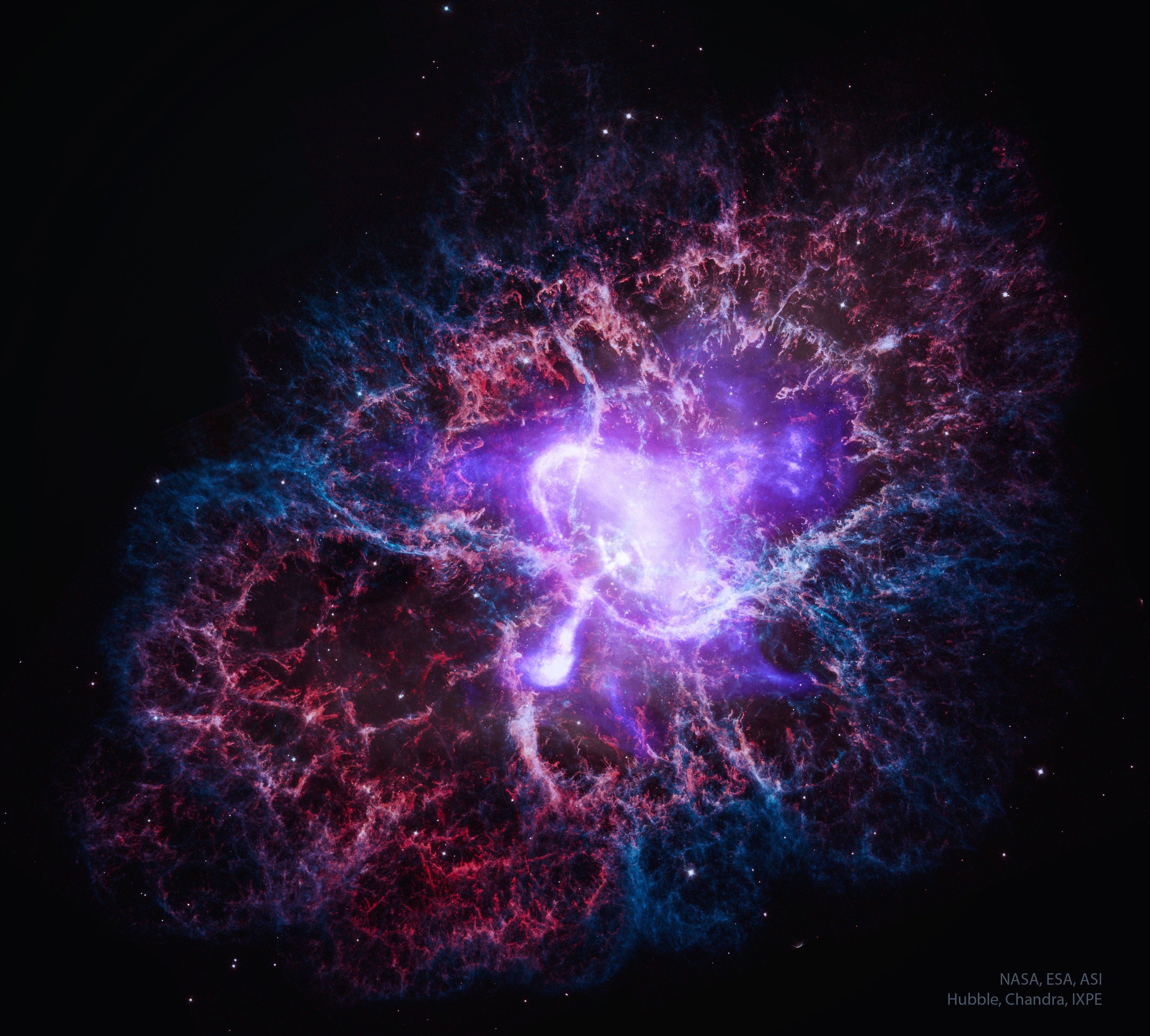 What powers the Crab Nebula? A city-sized magnetized neutron star spinning around 30 times a second. Known as the Crab Pulsar, it is the bright spot in the center of the gaseous swirl at the nebula's core.  About 10 light-years across, the spectacular picture of the Crab Nebula (M1) frames a swirling central disk and complex filaments of surrounding and expanding glowing gas. The picture combines visible light from the Hubble Space Telescope in red and blue with X-ray light from the Chandra X-ray Observatory shown in white, and diffuse X-ray emission detected by Imaging X-ray Polarimetry Explorer (IXPE) in diffuse purple.  The central pulsar powers the Crab Nebula's emission and expansion by slightly slowing its spin rate, which drives out a wind of energetic electrons.  The featured image released today, the 25th Anniversary of the launch of NASA's flagship-class X-ray Observatory: Chandra.    Many Discoveries: Chandra Celebrates 25th Anniversary